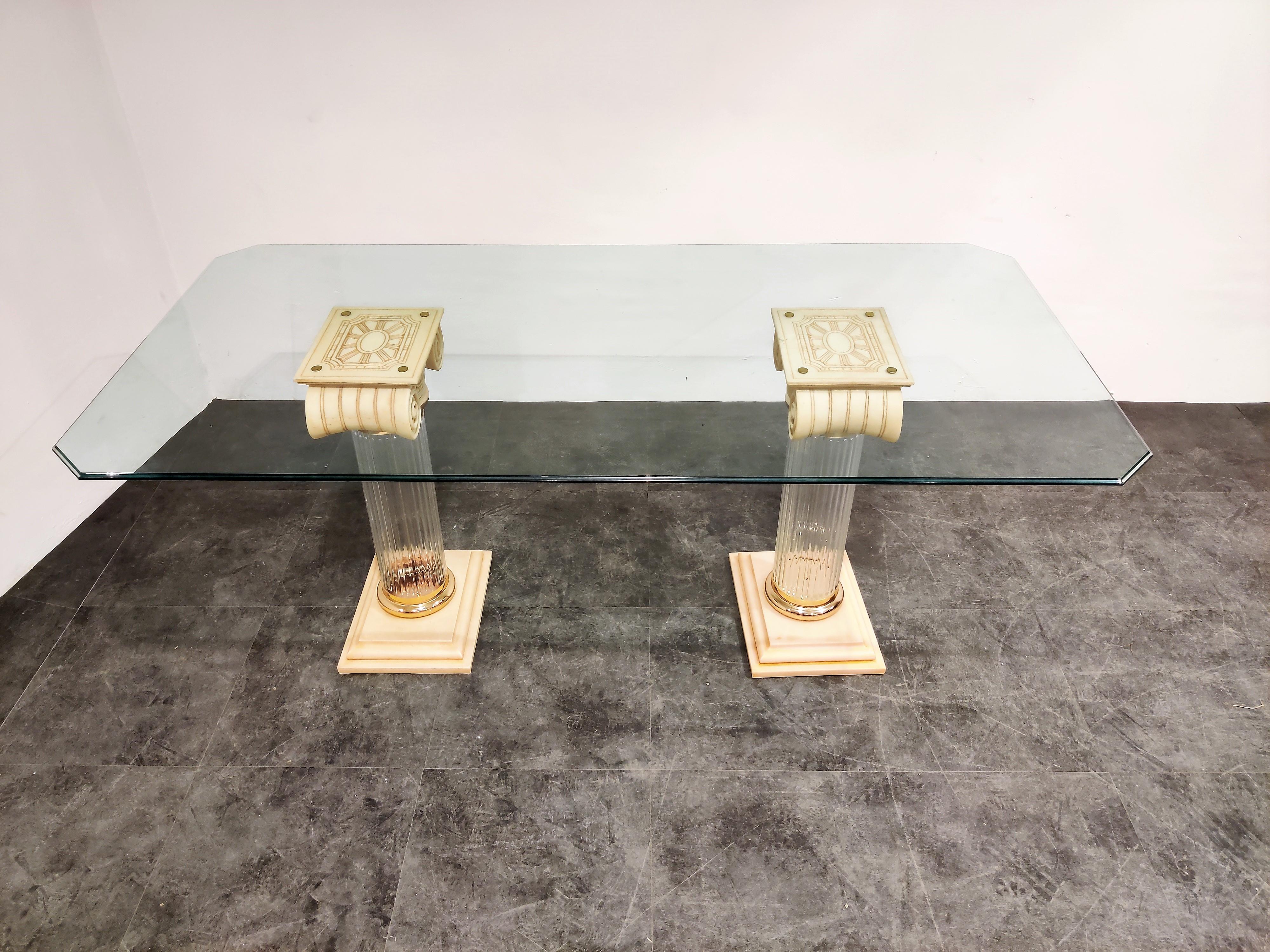 Remarkable dining table consisting of two geek style columns made from Lucite, brass and resin with a clear beveled glass top.

Eyecatcher for your dining room. 

Good condition

1980s, Belgium

Measures: Height 74cm/ 29.13