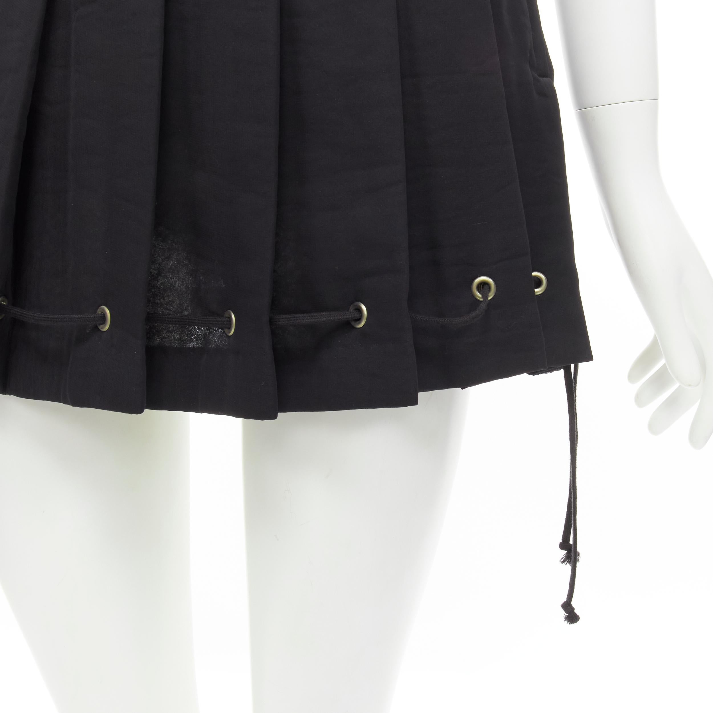 vintage COMME DES GARCONS 1980s black pleated drawstring hem mini skirt S 
Reference: CRTI/A00486 
Brand: Comme Des Garcons 
Collection: 1980s 
Material: Polyester 
Color: Black 
Pattern: Solid Closure: Zip 
Extra Detail: Pleated skirt. Silver