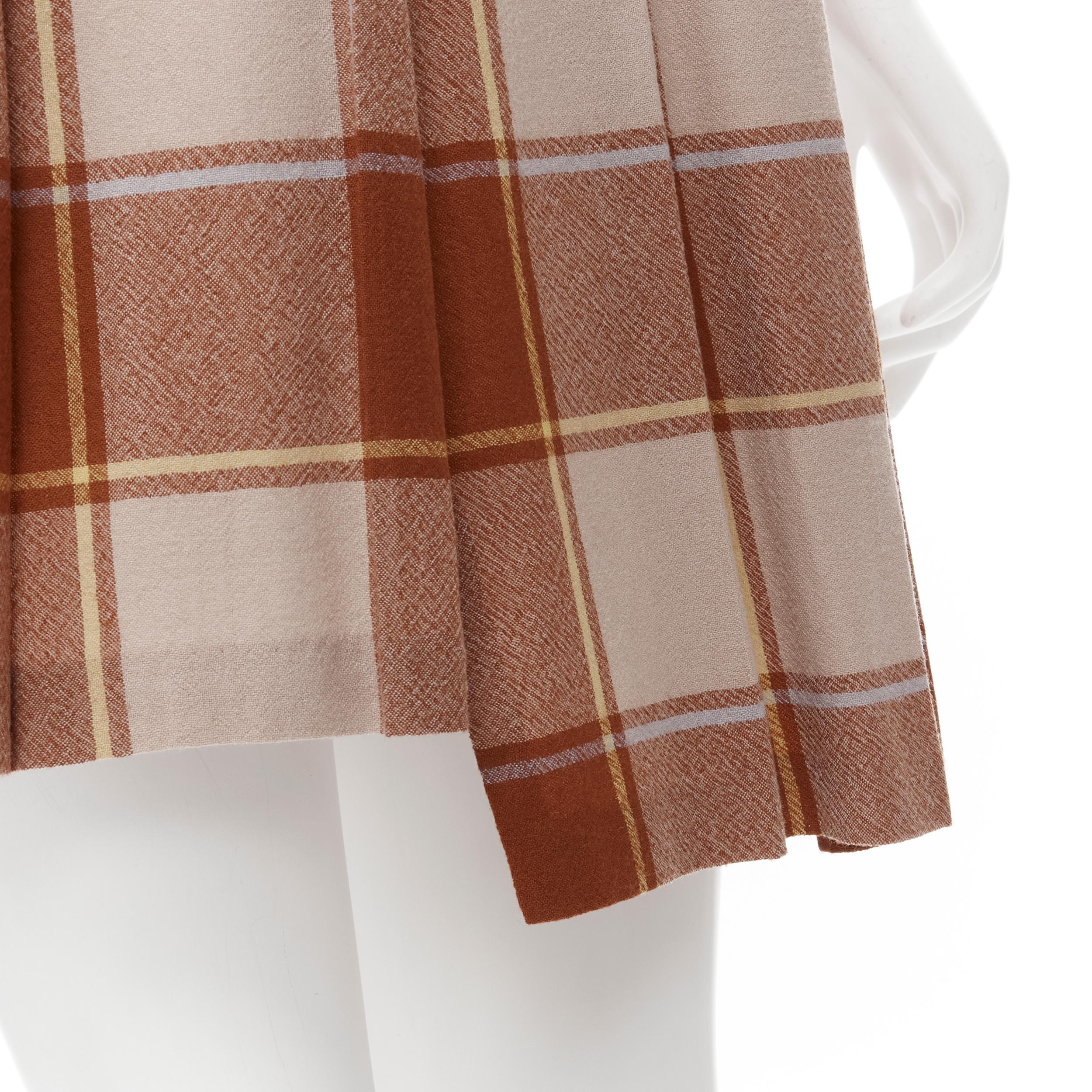 vintage COMME DES GARCONS 80s brown plaid check pleated step hem wool skirt 
Reference: CRTI/A00306 
Brand: Comme Des Garcons 
Designer: Rei Kawakubo 
Material: Wool 
Color: Brown 
Pattern: Check 
Closure: Zip 
Made in: Japan 

CONDITION: