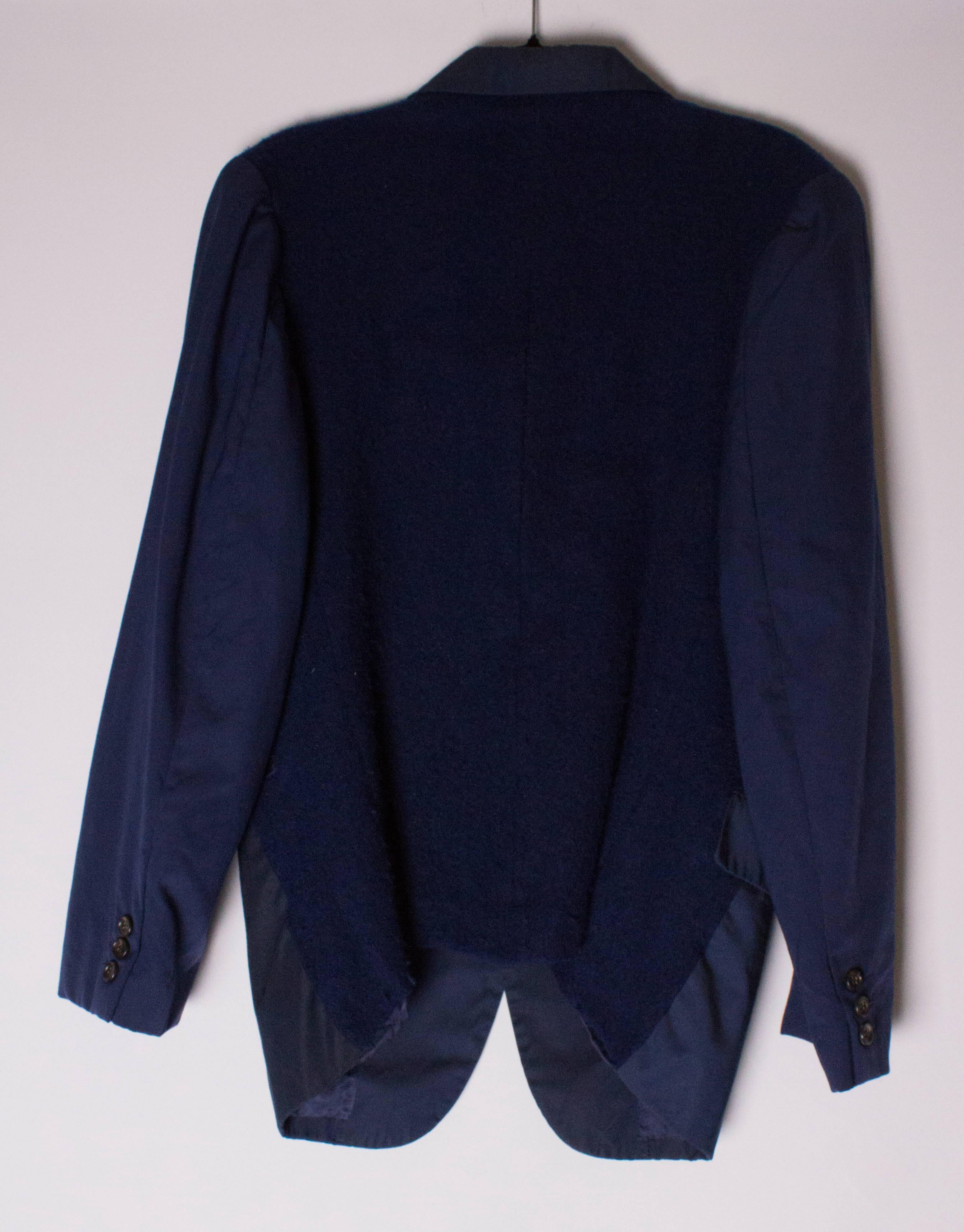 A great navy blue jacket by Comme des Garcons,  Homme Plus range.
The main part of the jacket is wool , and the back is a boucle like fabric.The back is unlined and the front of the jacket lined.  It has one chest pocket and two waist pockets.

