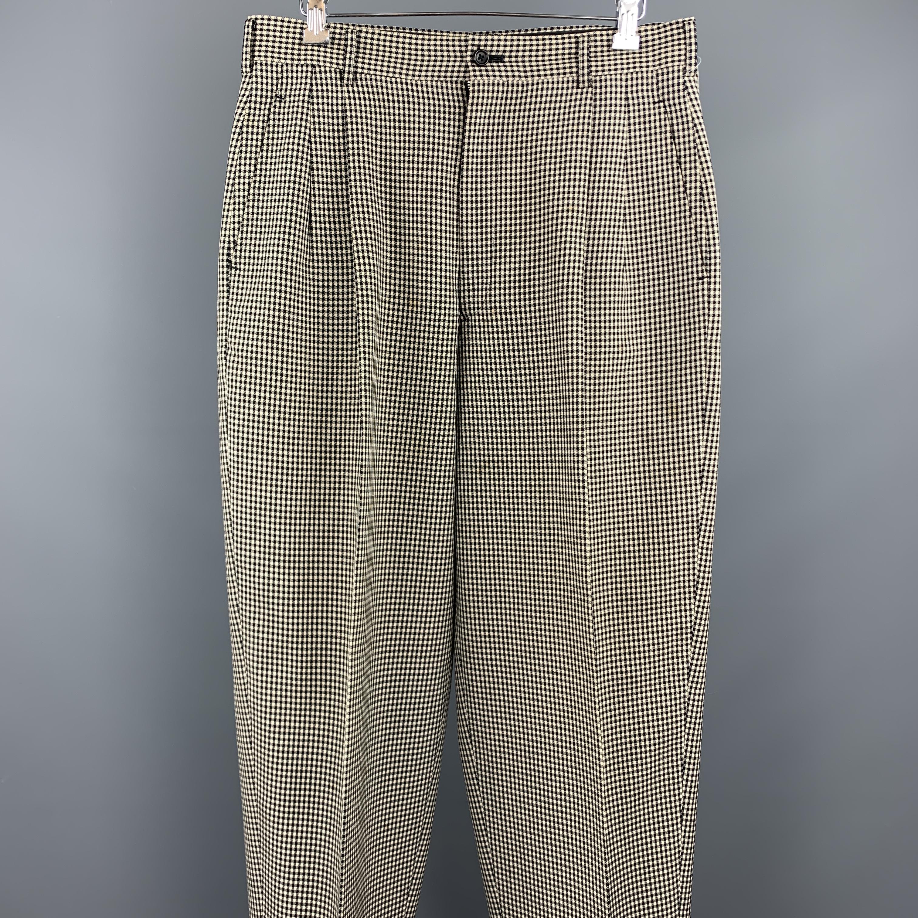 Vintage COMME des GARCONS HOMME PLUS casual pants comes in a black and white nailhead wool featuring a pleated style, leg cuffs, and a zip fly closure. Minor discoloration on lower left leg. Made in Japan. 

Very Good Pre-Owned Condition.
Marked: JP