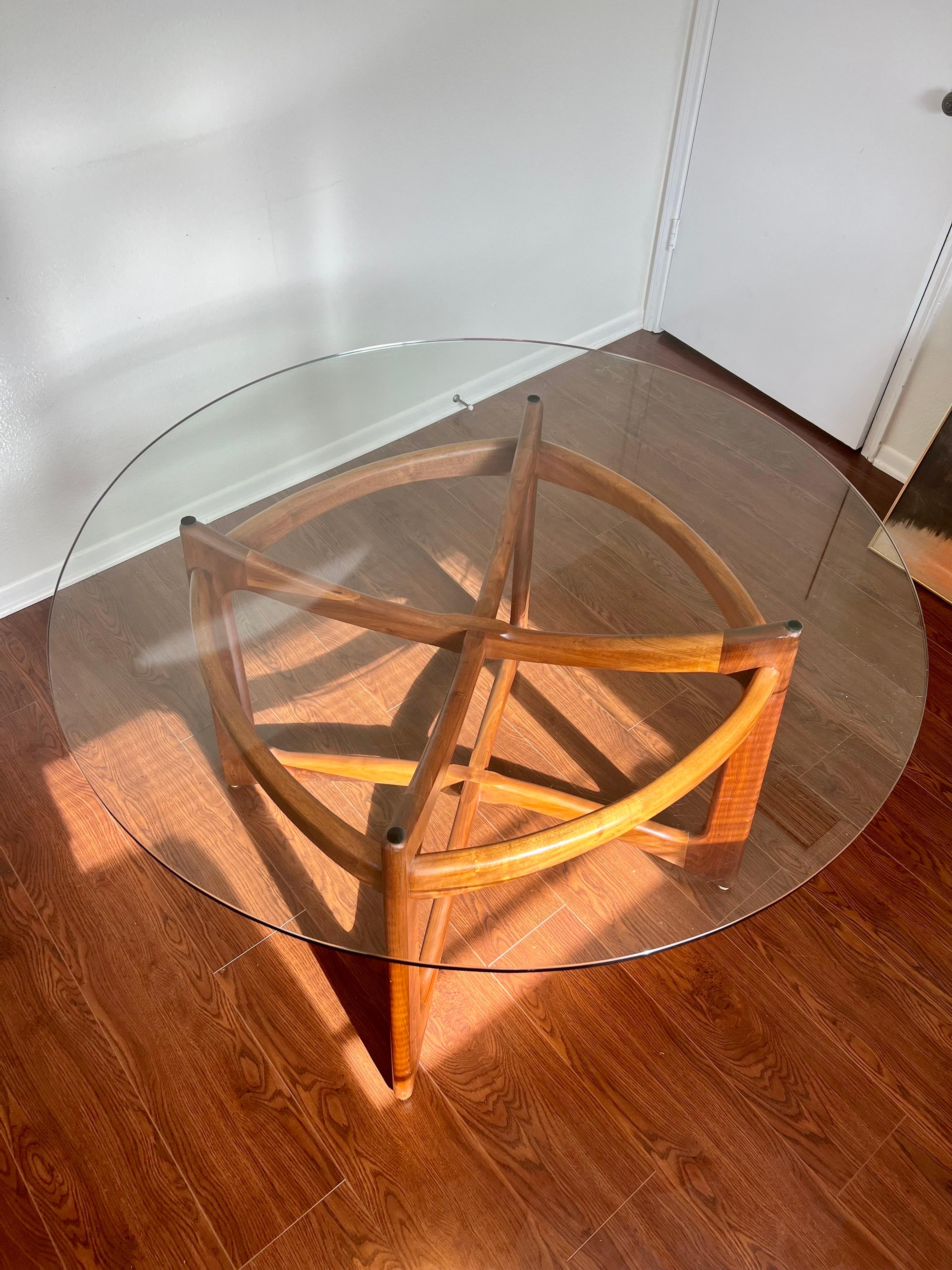 Vintage compass dining table model no. 2458-T48 designed by Adrian Pearsall of Craft Associates. This sculptural piece is constructed of solid walnut and includes the original pencil edge glass top. In good/excellent condition with some minor