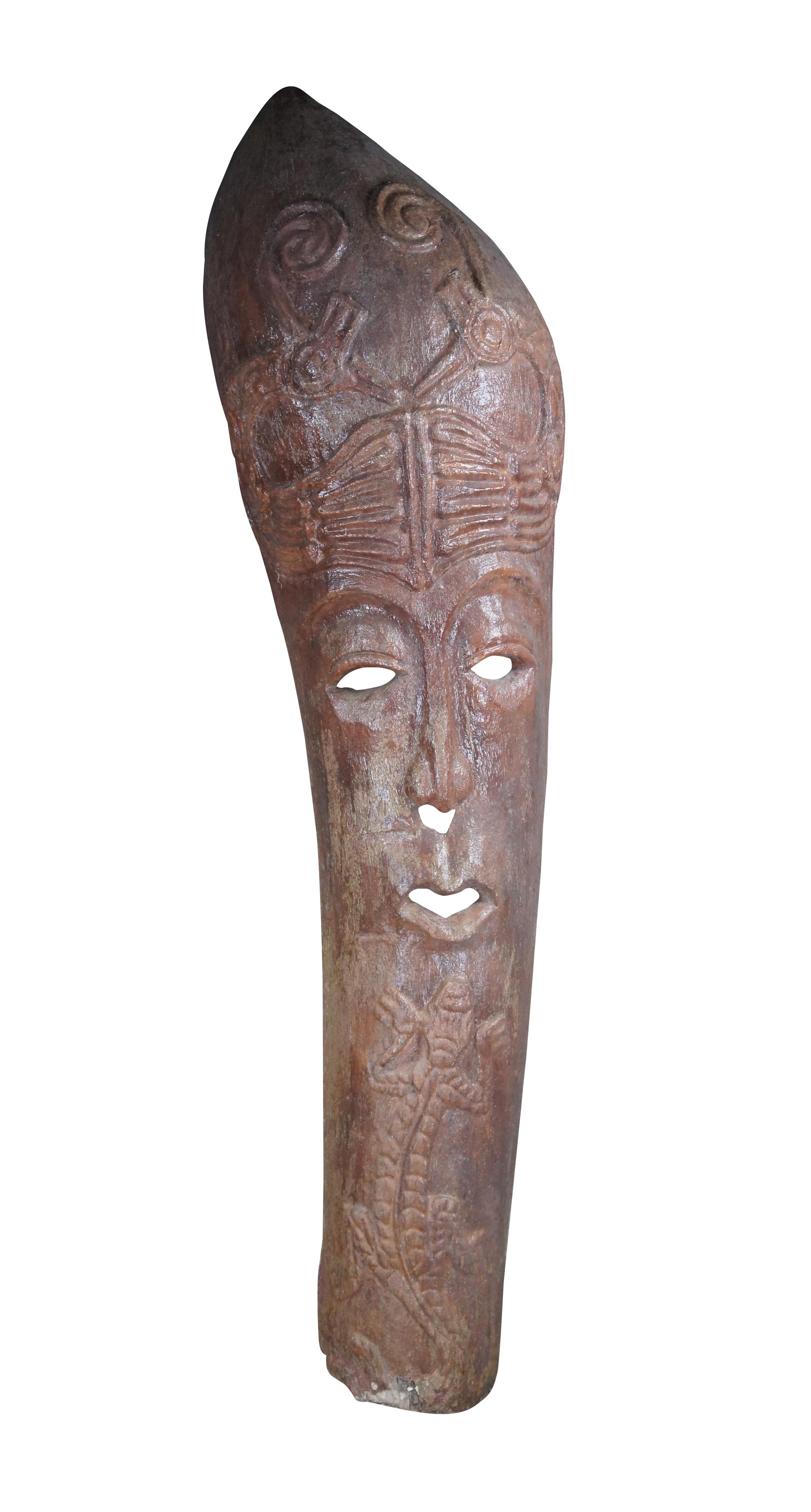 Large vintage Balinese style tiki hut tribal mask or statue. Made of a composite material in the form of an old Palm trunk featuring a large elongated face with a gecko / lizard and birds.