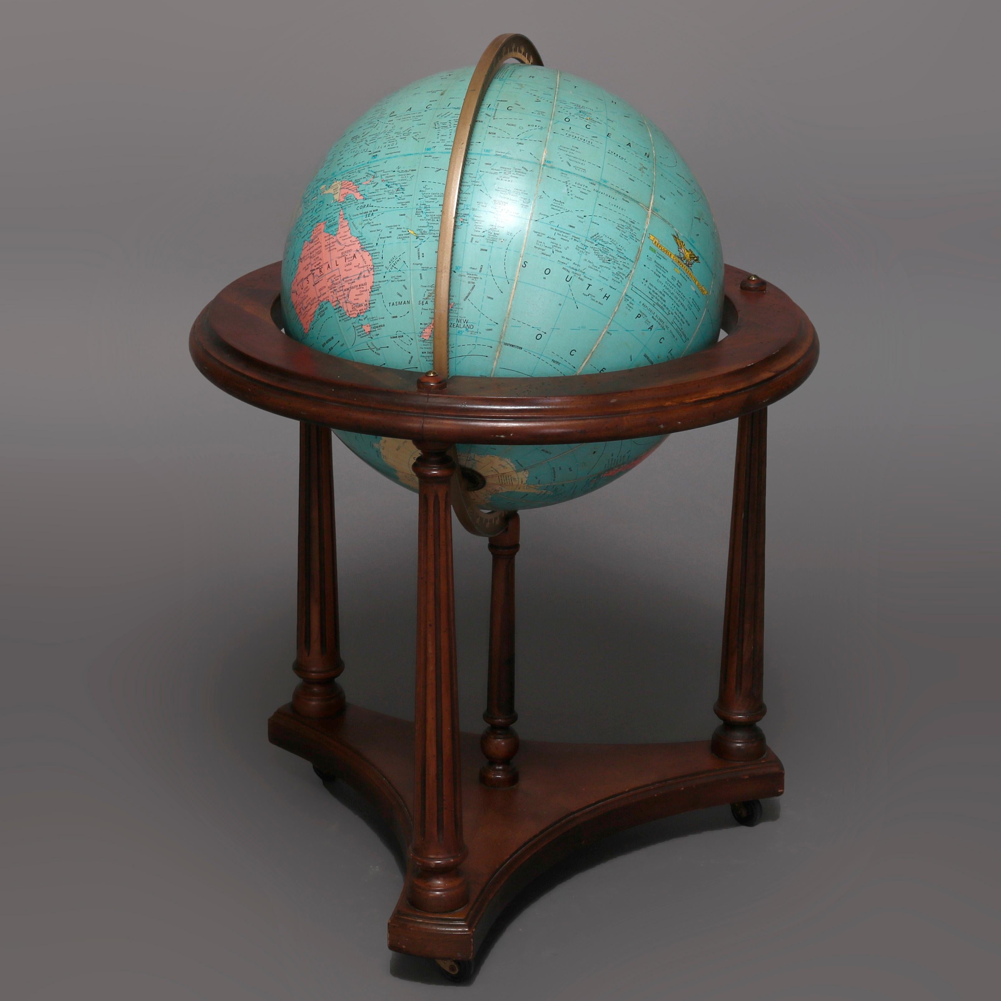 A vintage comprehensive world globe seated and swivels within Stand having mahogany construction with three turned and reeded legs by Replogle Globes Inc., office model, 20th century.

Measures: 32