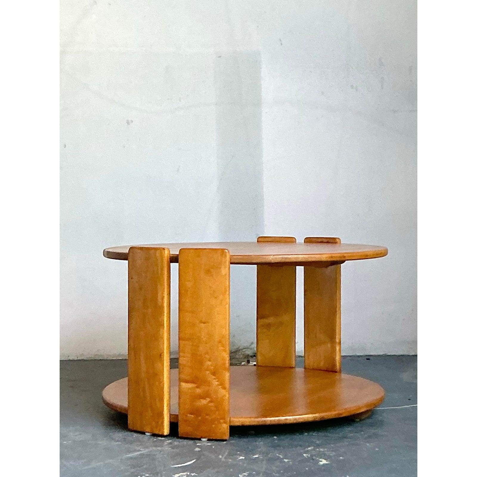 A fantastic example of American Mid-Century Modern design, this sculptural coffee table by the renowned Conant Ball company is a celebration of solid maple craftsmanship. Its striking form is defined by unique, robust slab legs that elegantly pierce