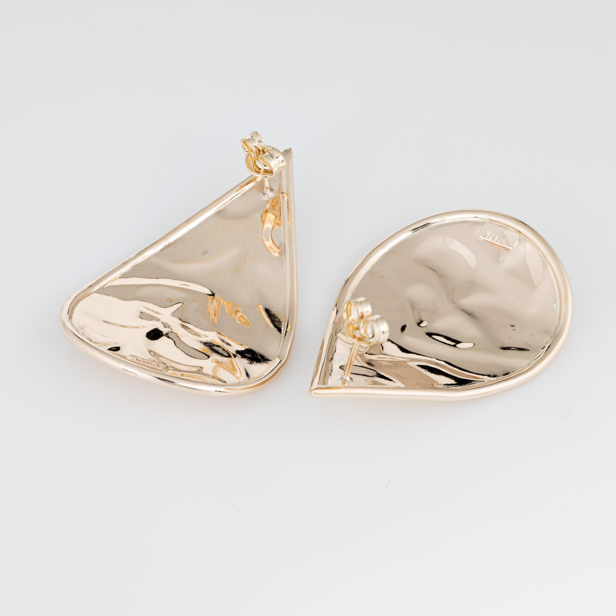 Elegant pair of vintage earrings crafted in 14k yellow gold. 

The large stylish earrings feature a textured design within the pear shaped mounts. Ideal for day or evening wear. The earrings are fitted with post and butterfly backings for pierced