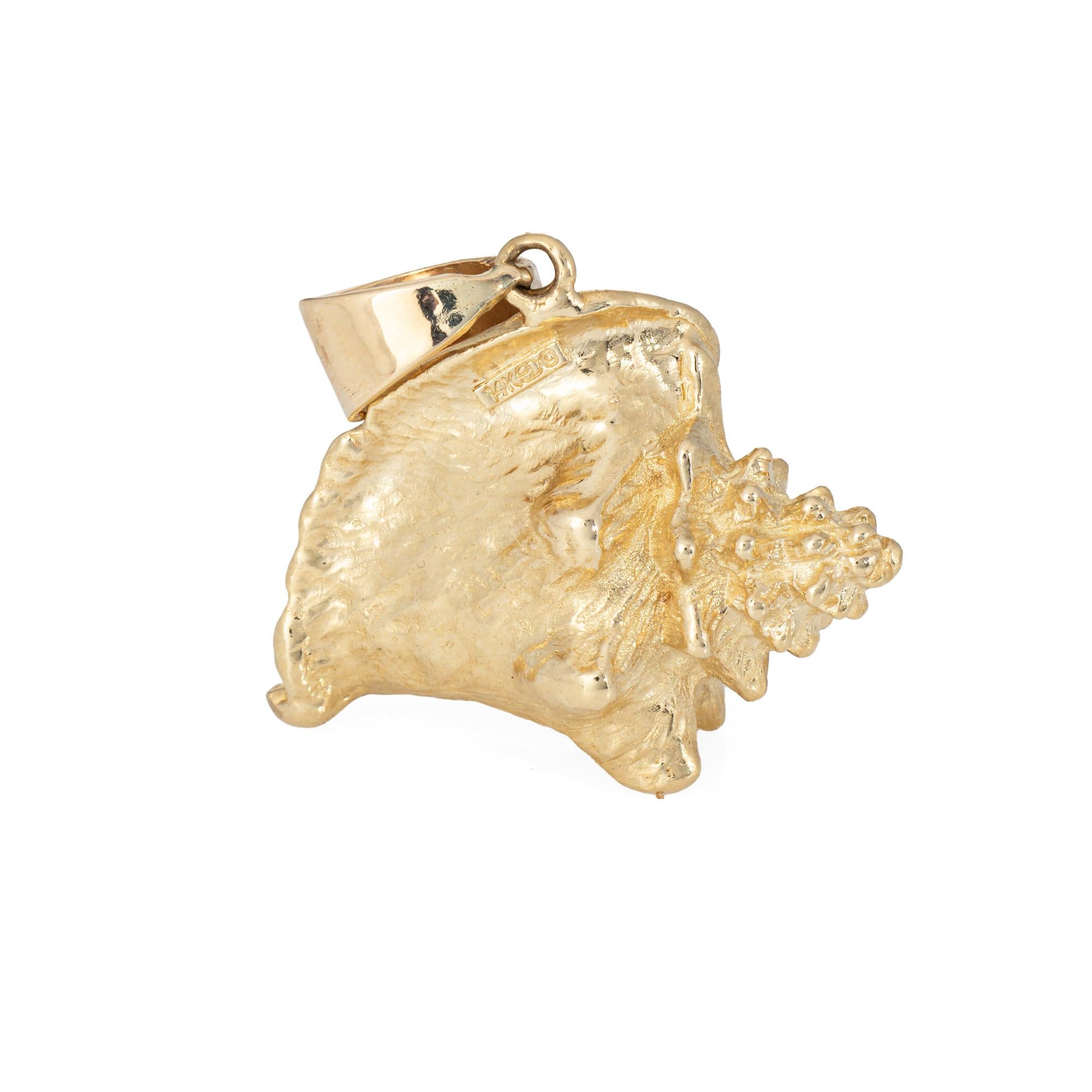 Finely detailed vintage conch shell pendant crafted in 14k yellow gold (circa 1970s).  

The beautifully detailed large 3-dimensional conch shell makes a statement! A nod to the ocean and everything you love about the beach, the pendant weighs a