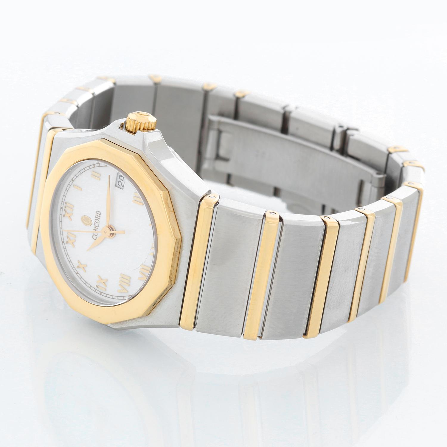 Vintage Concord Mariner Ladies Watch - Quartz. Stainless steel with yellow gold bezel ( 27 mm ). White dial with raised Roman numerals. Two tone bracelet; will fit up to a 6 inch wrist. pre-owned with custom box .