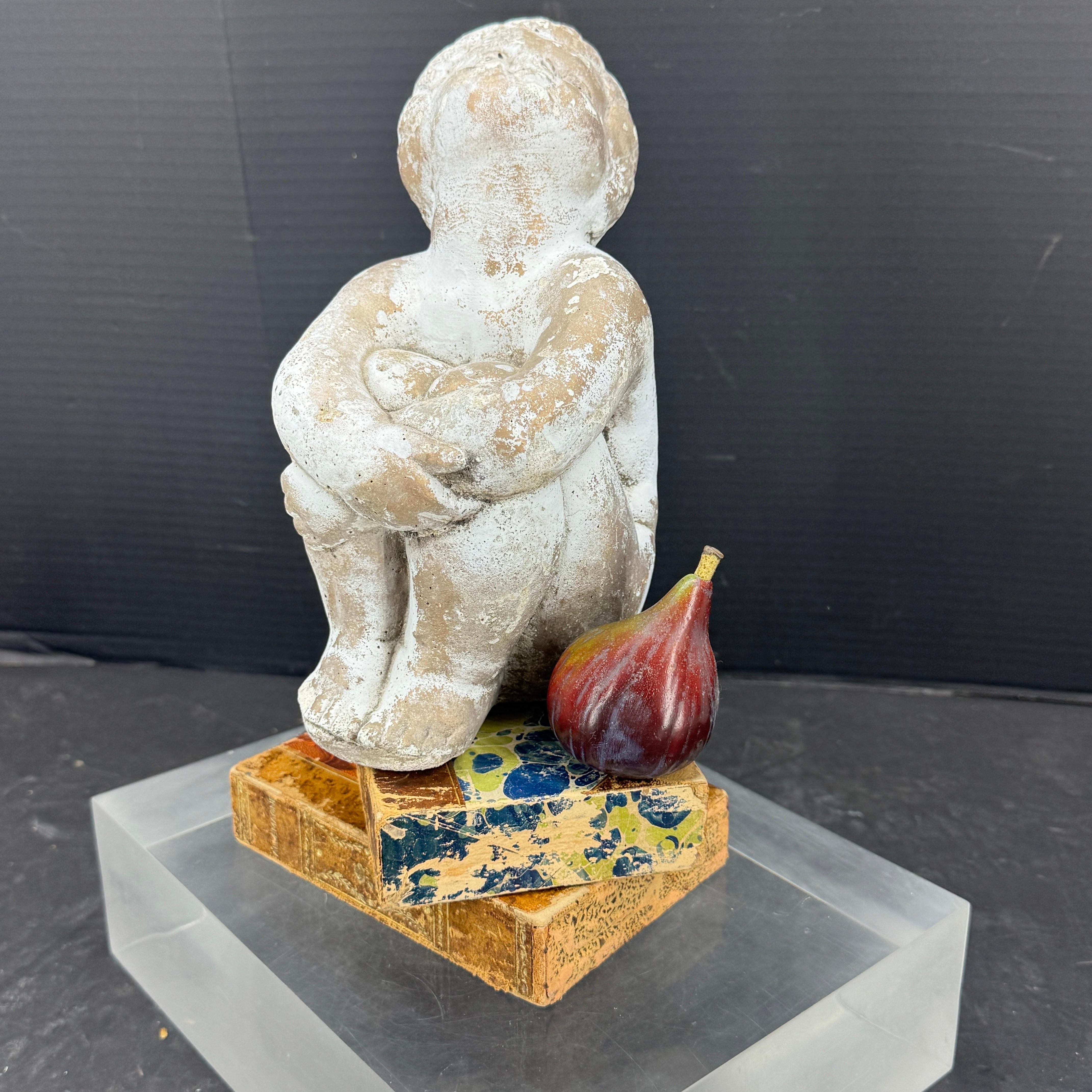 Charming girl sculpture with a lovely patina. This statue could be used indoors or out. We see her sitting on a coffee table atop books or in an outdoor garden. Certainly, a delightful way to add a touch of vintage charm to your home. 
