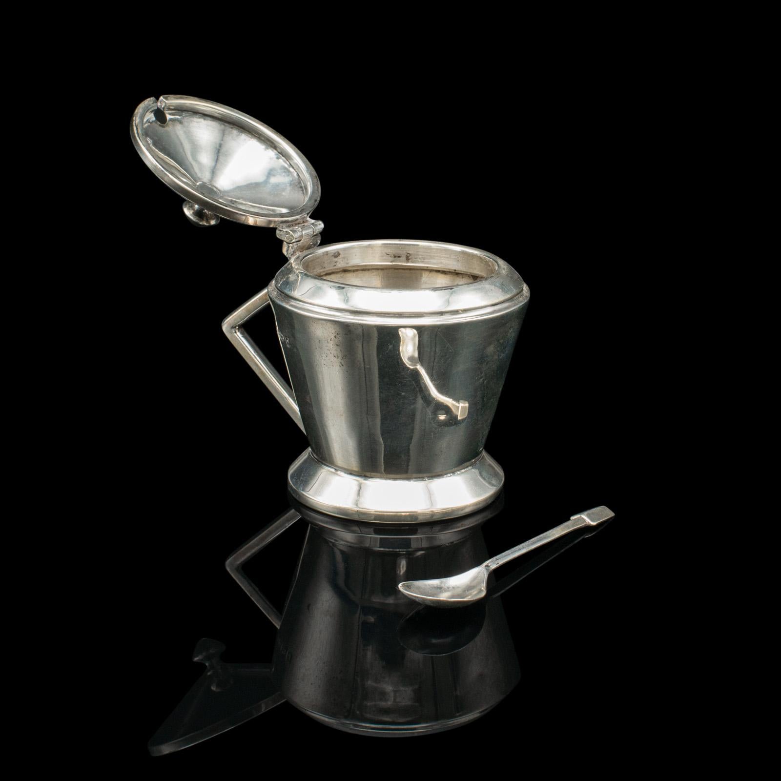 This is a vintage condiment set. An English, Sterling Silver salt & pepper shaker and mustard pot in Art Deco taste, dating to the mid 20th century, hallmarked 1933.

Charming hallmarked tableware with appealing Art Deco forms
Displaying a desirable