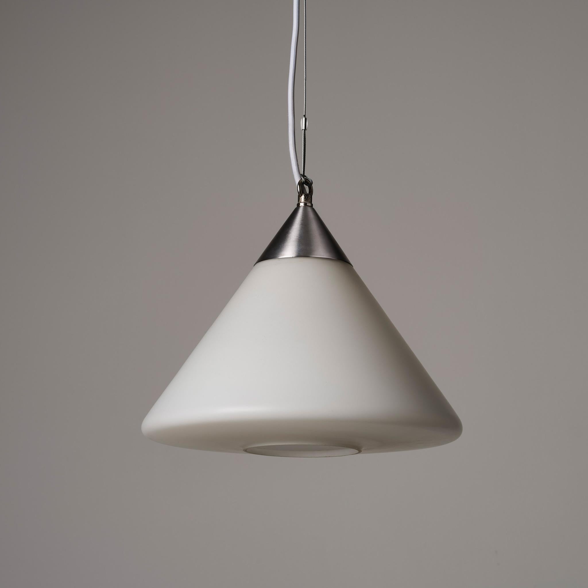 Vintage 1960’s white glass pendant lights salvaged from a school in the Midlands. Conical matt glass shades mounted on the original brushed steel galleries. The glass diffuses the light to a warm glow.