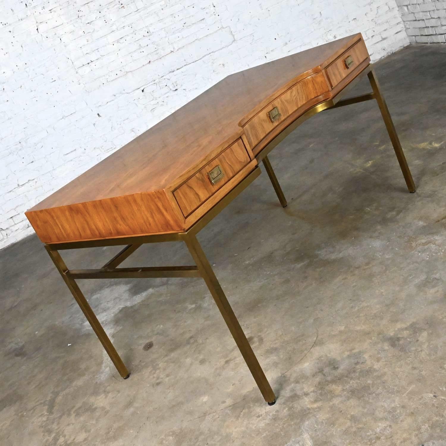 Handsome vintage ash veneer MCM writing desk on a brass plated metal frame with solid brass pulls from the Consensus Collection by Drexel. Beautiful condition, keeping in mind that this is vintage and not new so will have signs of use and wear. The