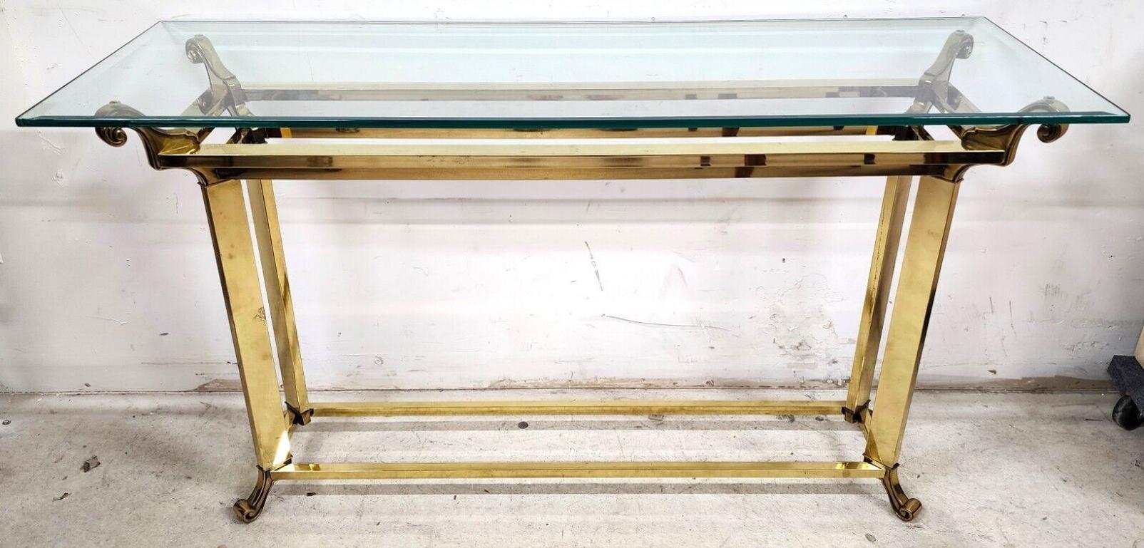 For FULL item description click on CONTINUE READING at the bottom of this page.

Offering One Of Our Recent Palm Beach Estate Fine Furniture Acquisitions Of A 
Vintage Mastercraft Style Glass & Brass Console Table in The Art Deco Hollywood Regency