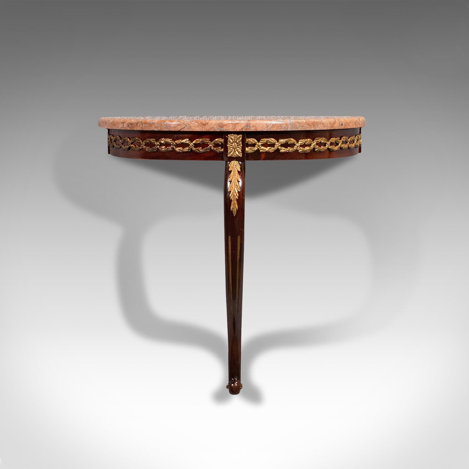 This is a vintage console table. A French, mahogany and marble wall table or candle shelf, dating to the late Art Deco period, circa 1940.

Art Deco taste and sinuous forms combine for this distinctive table
Displaying a desirable aged patina