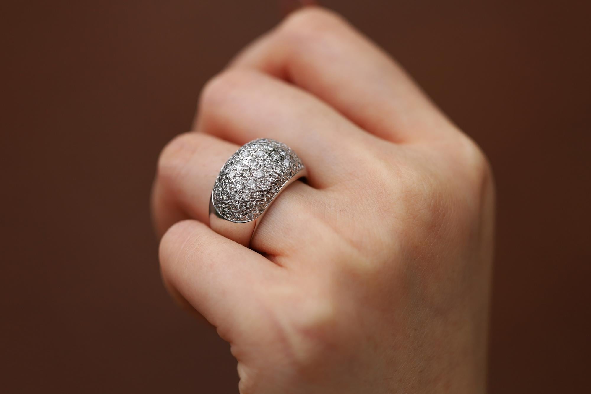 This classy contemporary dome ring is a fantastic piece that displays glimmering scintillation. The bombé ring boasts a stunning 1.50 carats of 70 natural pavé diamonds, sparkling with modern brilliance. Lovingly crafted with 14 karat white gold