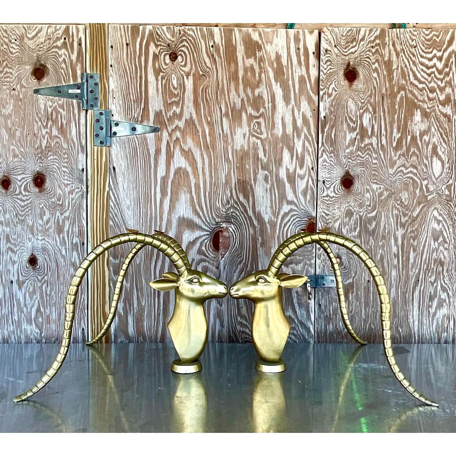 Spectacular pair of vintage Contemporary coffee table pedestals. Beautiful solid brass Ibex heads with glamorous long horns. No glass. Acquired from a Palm Beach estate.