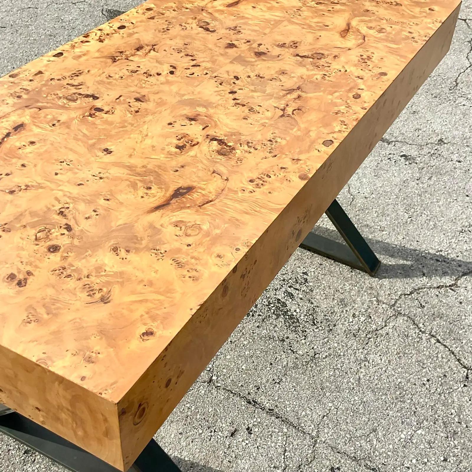 A fabulous vintage contemporary 80s writing desk. Done in the manner of the iconic Milo Baughman. Beautiful Burl wood top on brushed chrome X legs. Acquired from a Palm Beach estate.