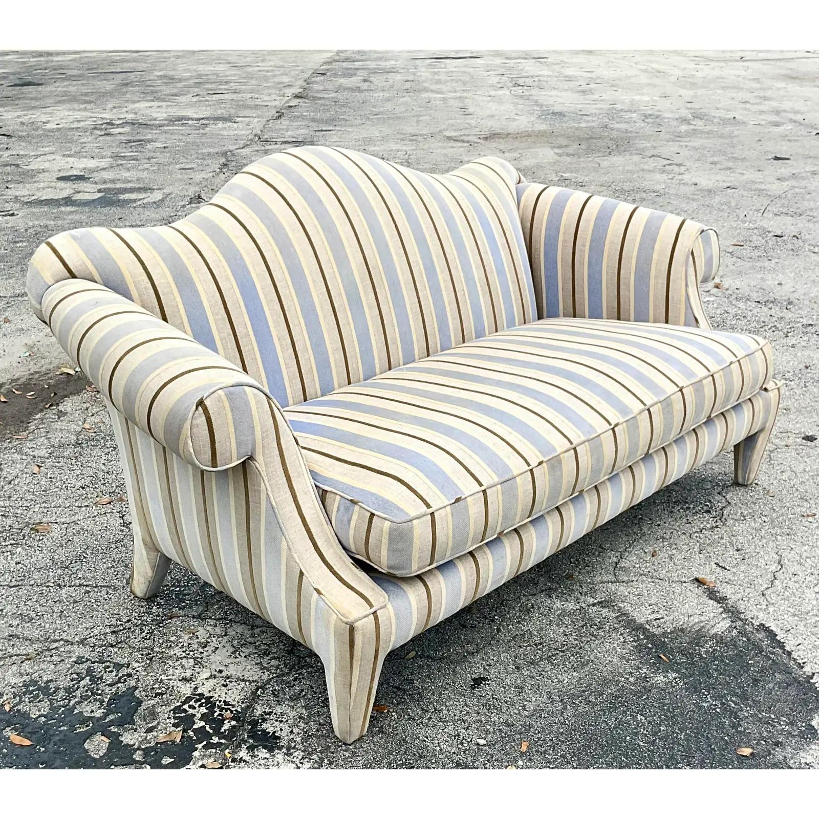 Fantastic vintage Camelback sofa. A classic Donghia shape in a sleek and sexy design. There are two available if you need a pair. Unmarked. Acquired from a Palm Beach estate.