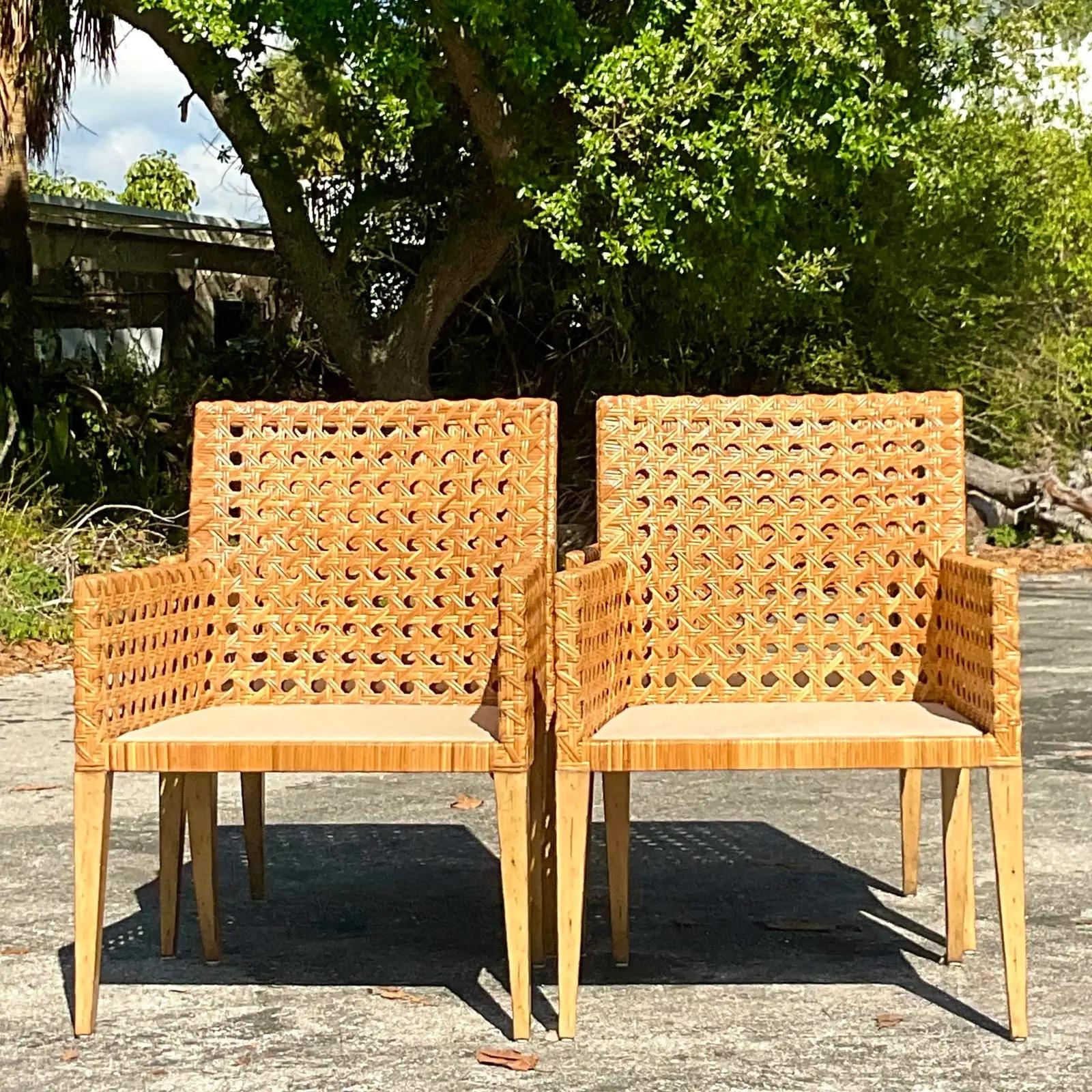 A fantastic vintage coastal set of four dining chairs. Chic all over cane in a clean modern design. Acquired from a Palm Beach estate.