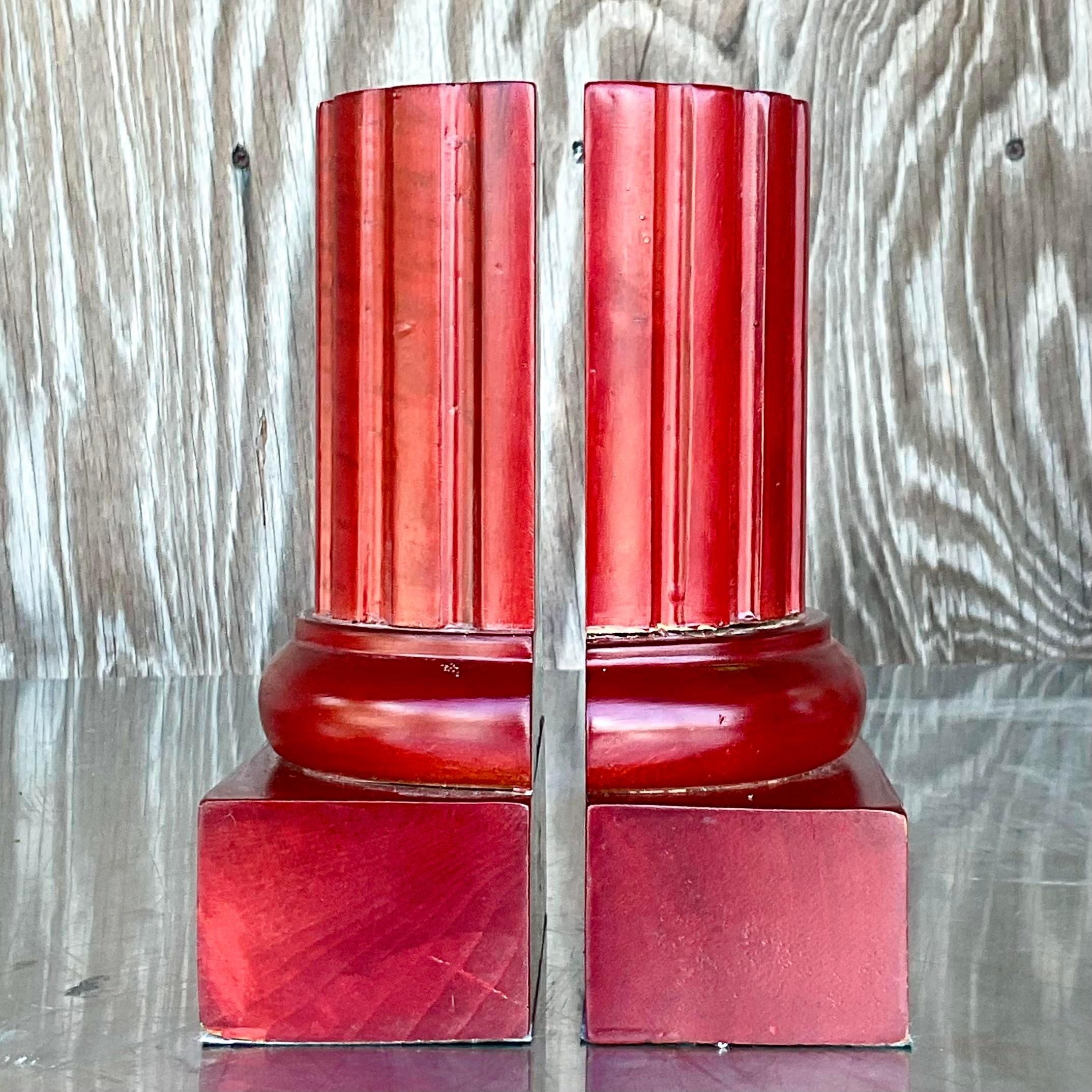 A fabulous pair of vintage Contemporary bookends. A beautiful deep red on a carved wooden column. A chic and simple design. Acquired from a Palm Beach estate.