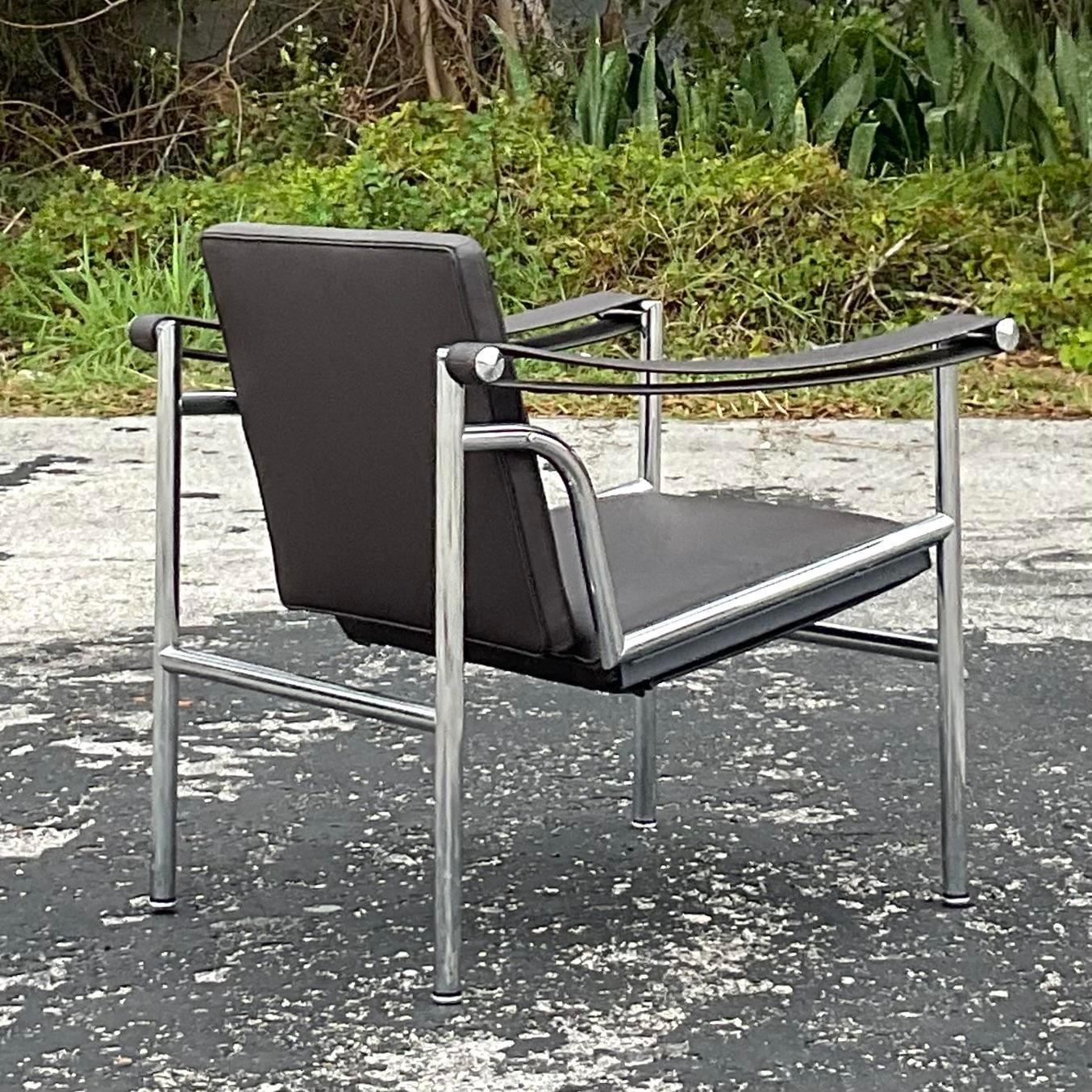 A fantastic vintage Contemporary leather lounge chair. The iconic Corbusier design made by the Cassina group in Italy. Beautiful chrome frame with a deep brown leather upholstery. Tagged on the back. Acquired from a Palm Beach estate.