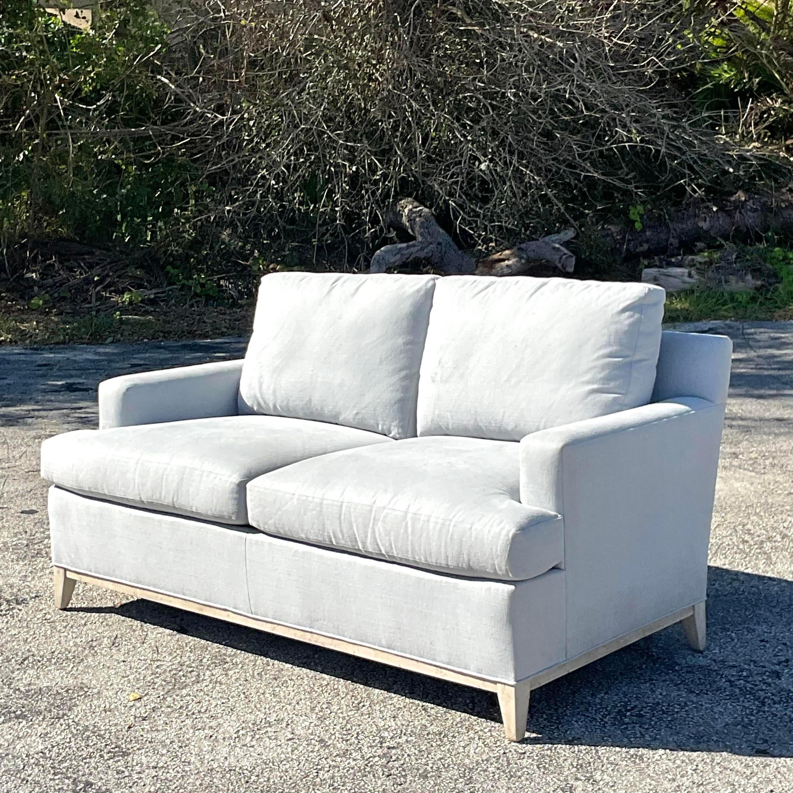 A fabulous vintage Coastal sofa. A chic pale blue on a custom built frame. Bigger than a loveseat, but a petite sofa. Super stylish. Acquired from a Palm Beach estate.