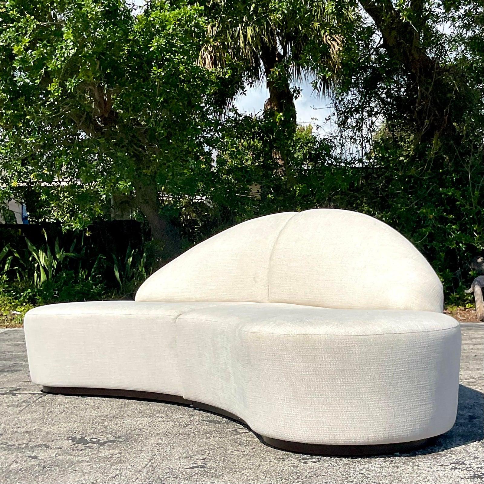 Indulge in luxury and sophistication with this vintage contemporary custom-built biomorphic boucle sofa. Crafted with meticulous attention to detail, it exudes American style with a modern twist, elevating any living space with comfort and elegance.
