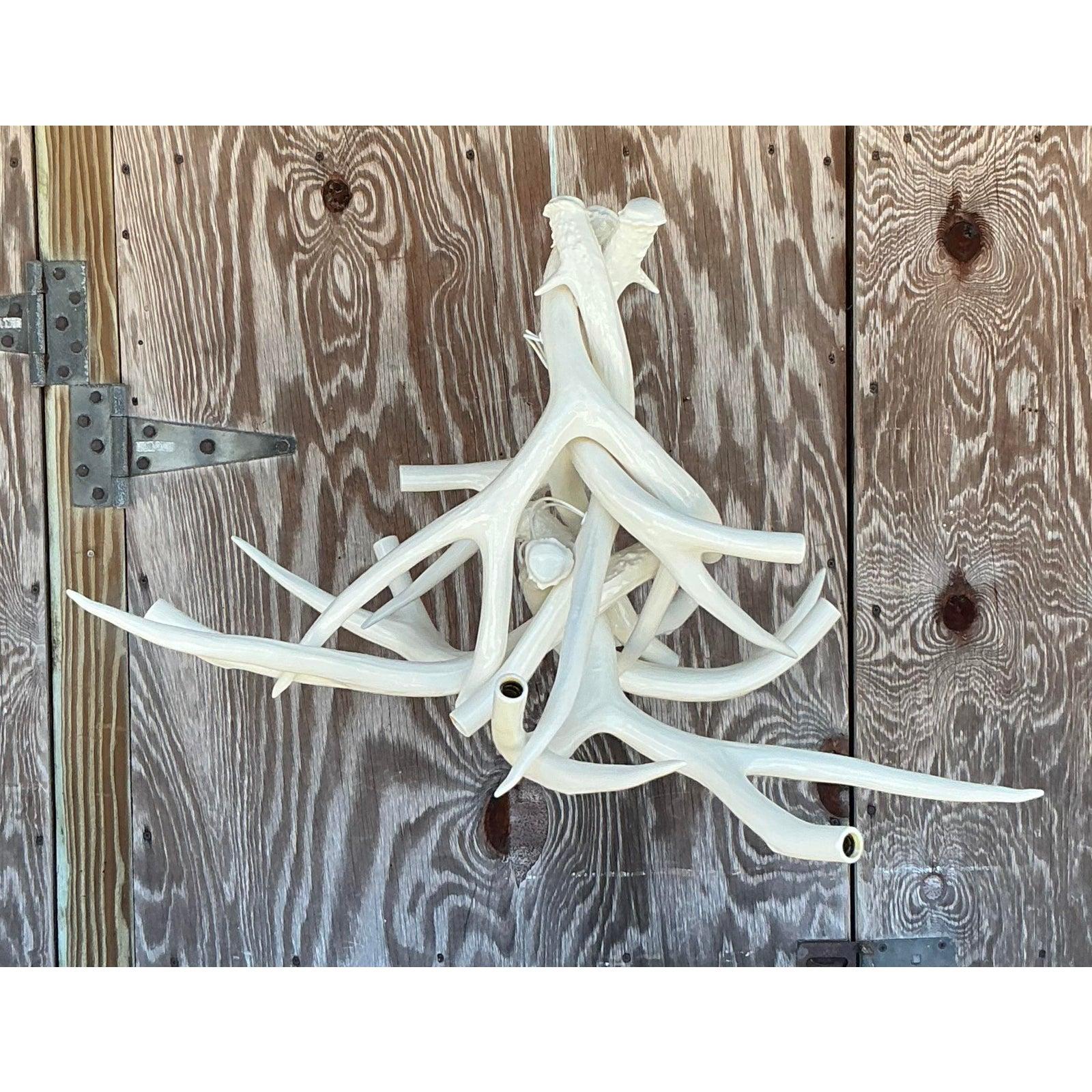 Designed by Jason Miller for Roll & Hill, this iconic ceramic antler chandelier redefines modern lighting with its striking organic form and artisanal craftsmanship. Each handcrafted ceramic 