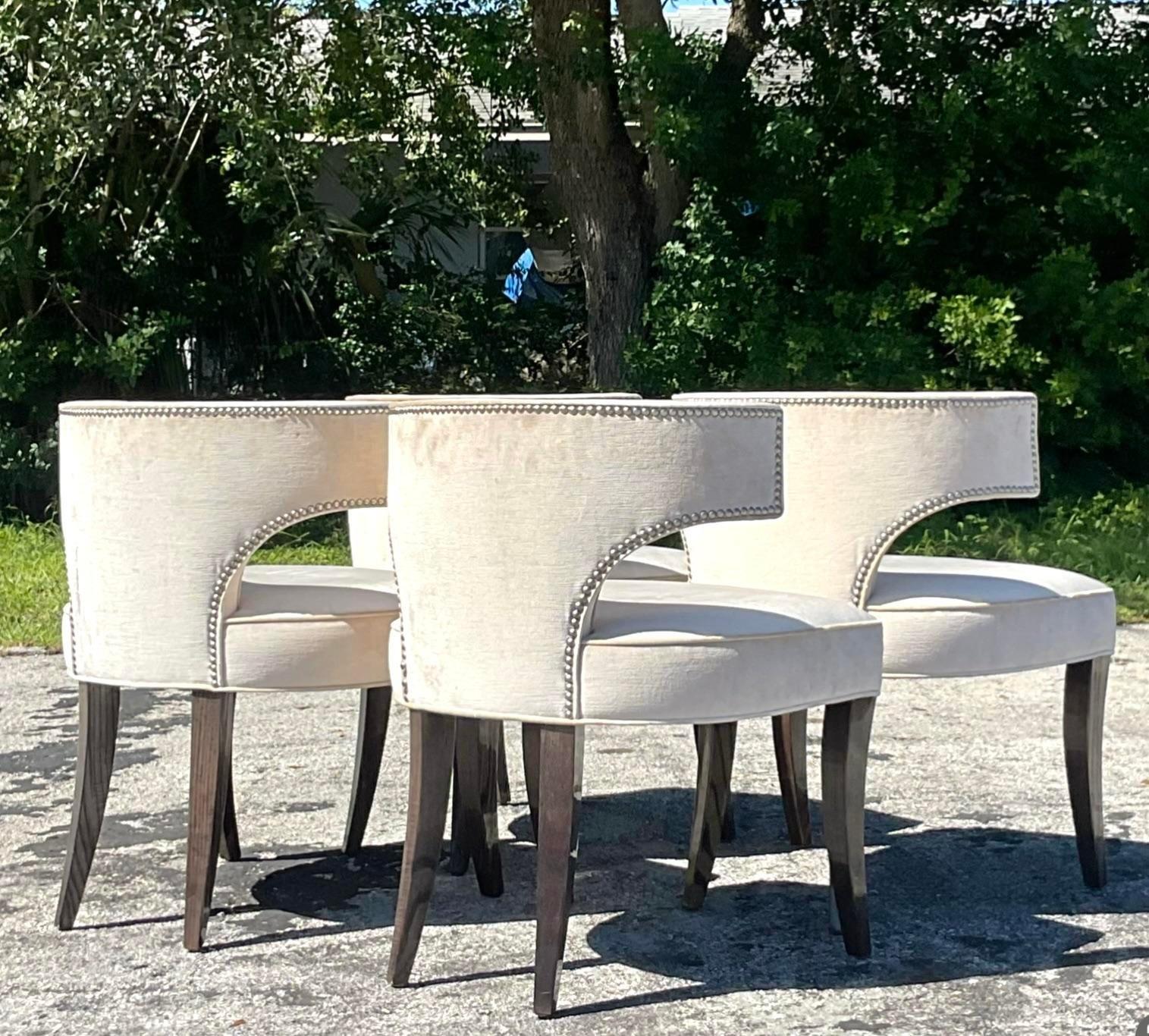 A fabulous set of four vintage Contemporary dining chairs. A chic Klismos inspired share with cerused Saber legs. Nailhead trim along the back. Acquired from a NY estate.