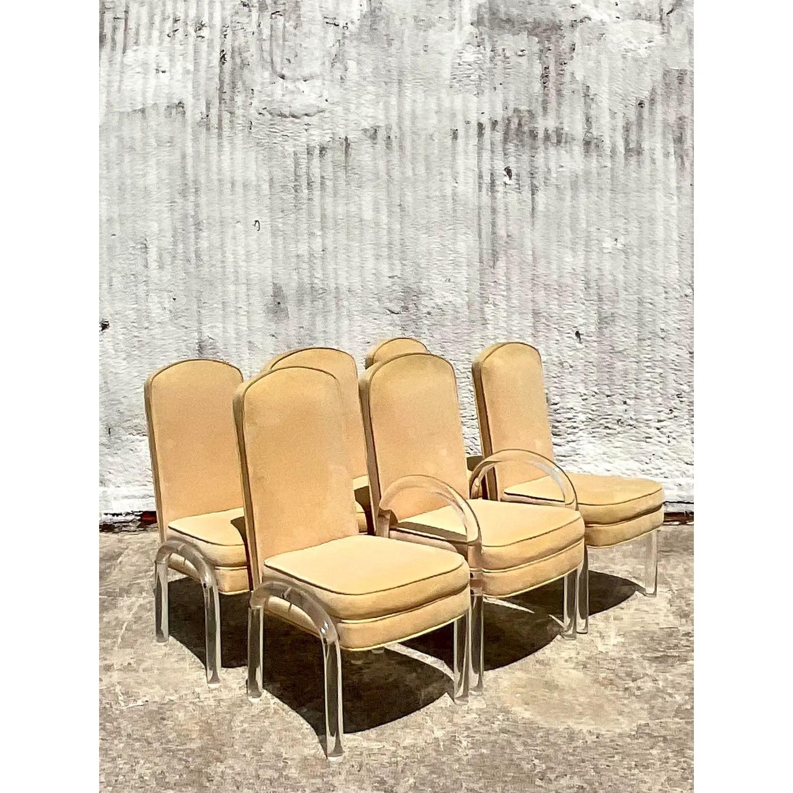 Stunning set of 6 vintage Contemporary dining chairs. A chic design with thick rods of lucite bent into an arched design. Stunning ultra suede upholstery in a soft yellow color. Matching dining table also available.