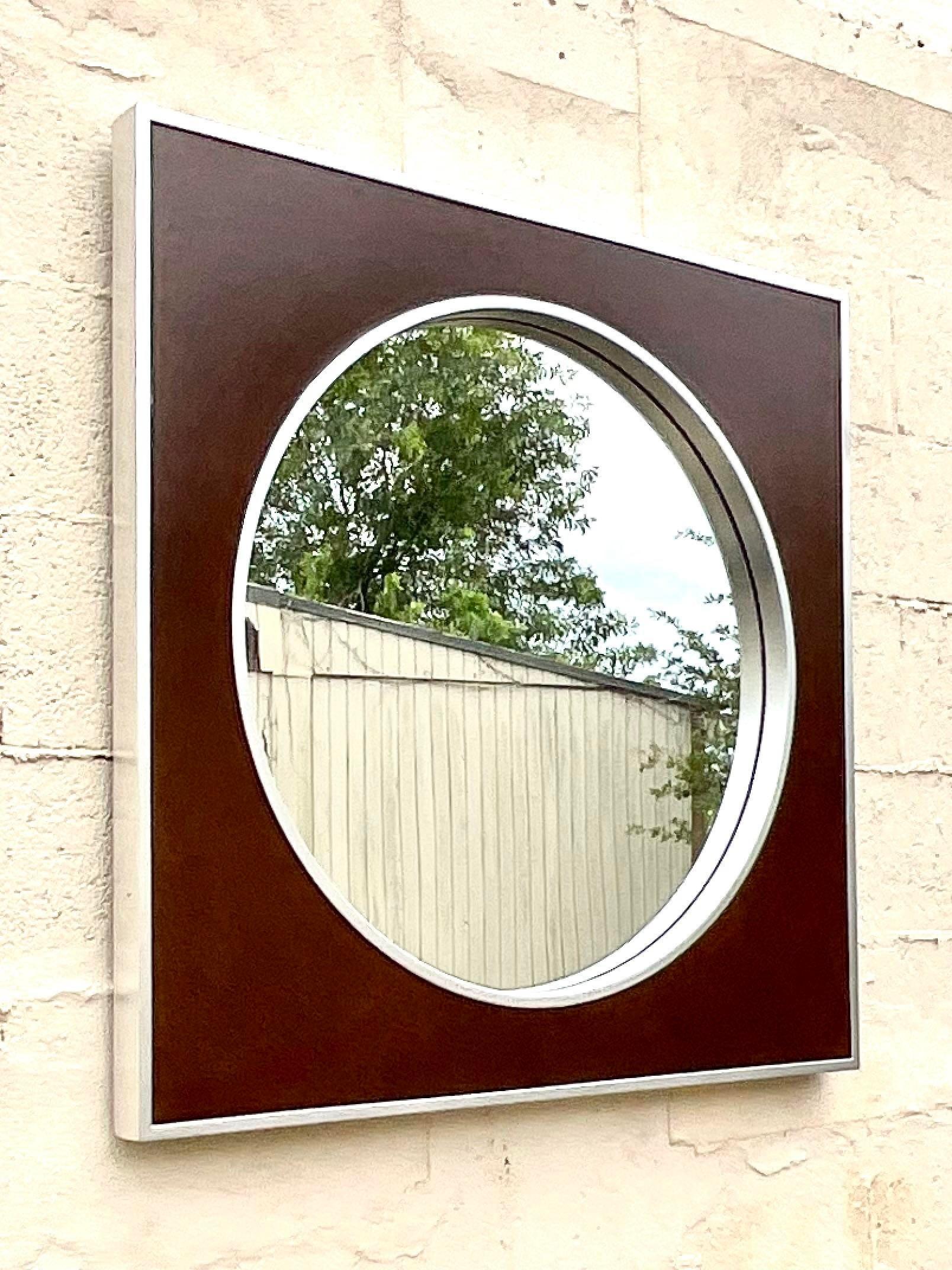 Fantastic vintage Contemporary wall mirror. Beautiful wood frame with a circle in the square design. Brushed chrome frame. Made by the iconic Majestic Mirror Company.