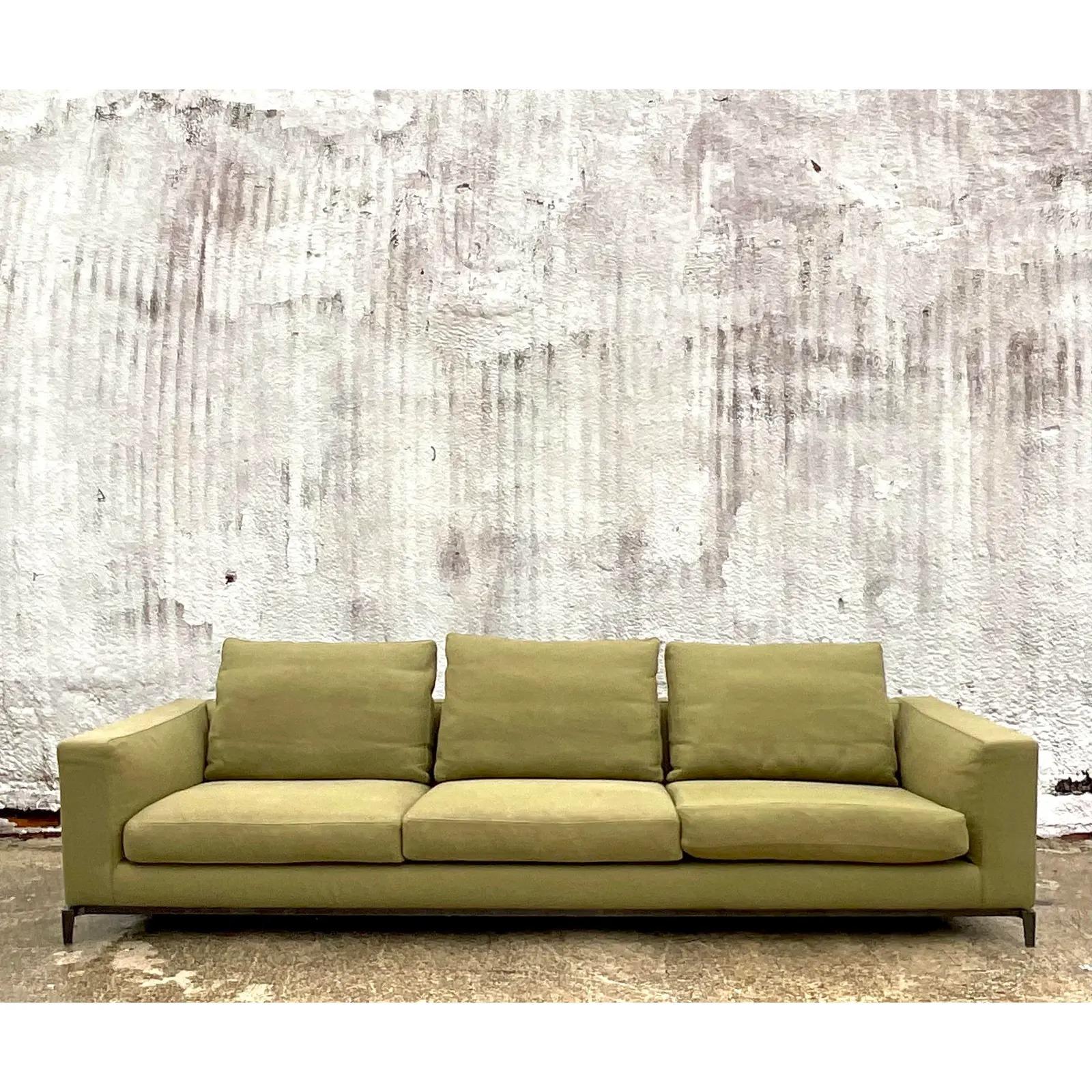A spectacular vintage Contemporary sofa. Made by the iconic Italian group Minotti Collezioni. A gorgeous Chartreuse green in a chic wide weave upholstery. Down filled cushions. Rests on a patinated plinth. Acquired from a Palm Beach estate.