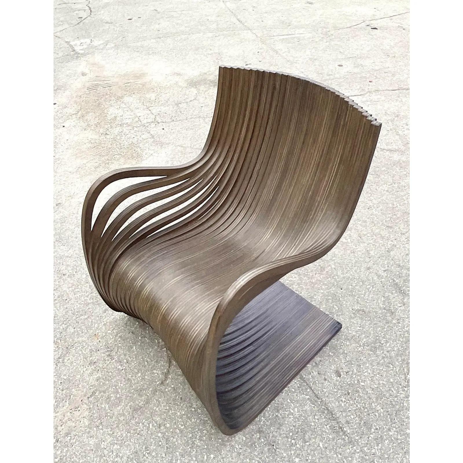 Incredible vintage Italian Contemporary lounge chair. Made by the iconic Piegatto Pipo. Beautiful Wenge wood construction in a beautiful wave design. Acquired from a Palm Beach estate.