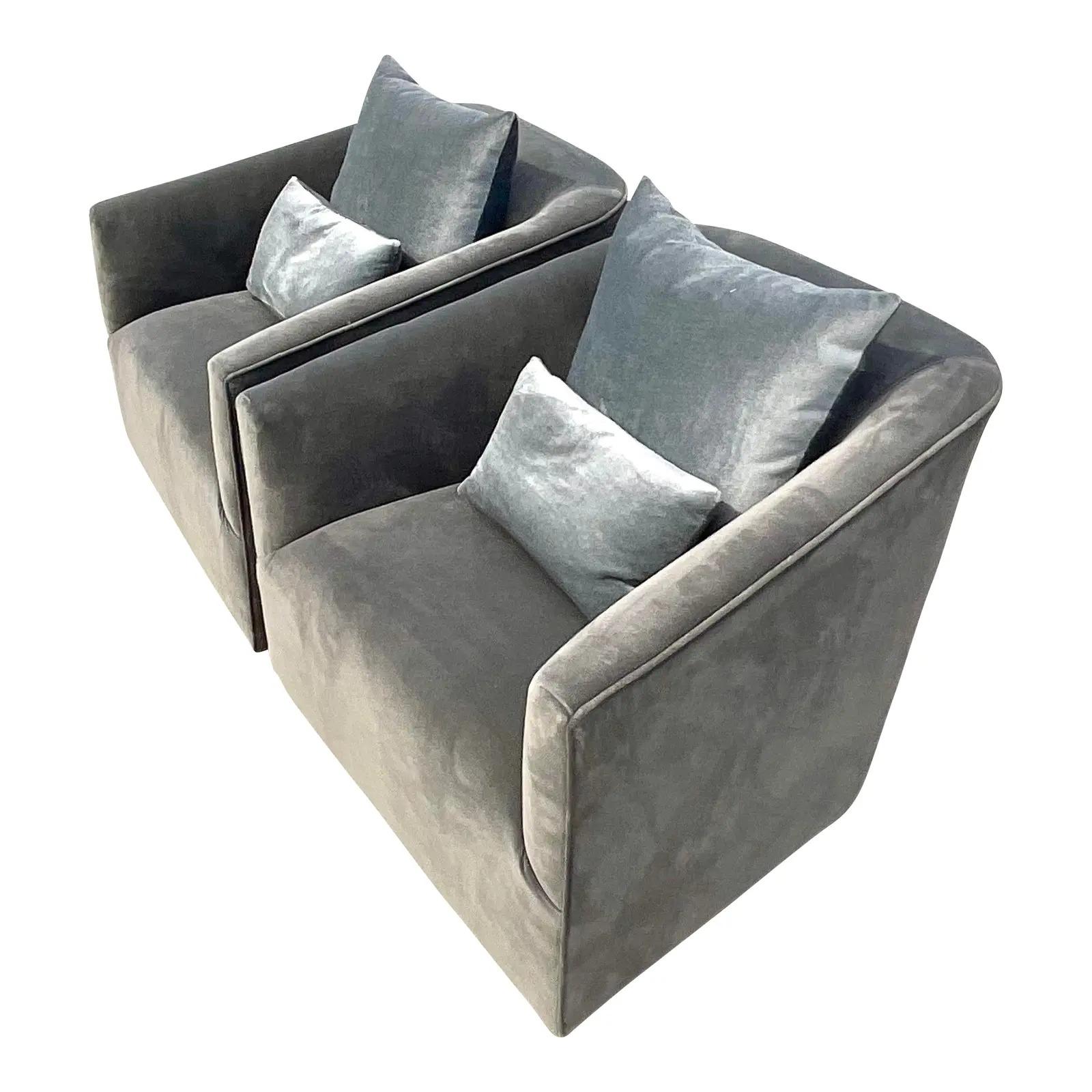 A fantastic pair of Restoration Hardware lounge chairs. The coveted Shelter Arm chair style in a chic smoke colored velvet. Rests on an ebony wooden plinth. Coordinating down throw pillows included. Acquired from a Palm Beach estate.
