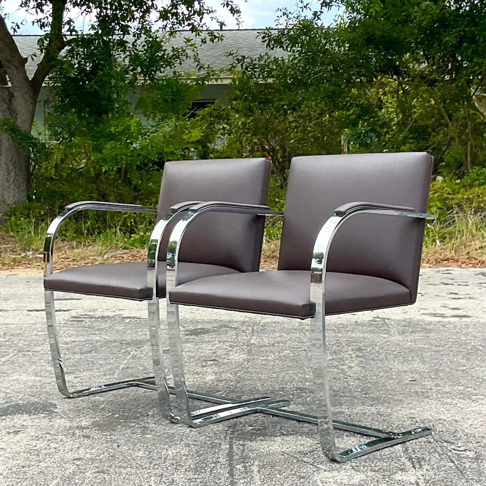 A pristine pair of vintage Contemporary Flat bar chrome chairs. Designed by the iconic Mies Van Der Rohe and produces by Knoll Studios. Signed on the bottom. Beautiful dark brown leather upholstery. Acquired from a Palm Beach estate.