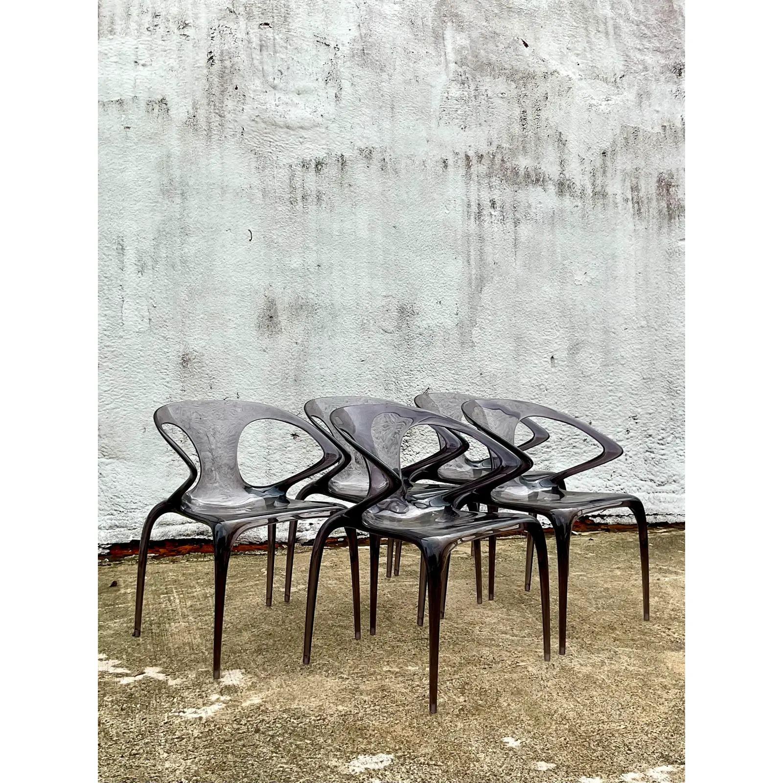 Incredible set of 5 vintage Italian Contemporary lucite dining chairs. Designed by Song Wen Zhong for Roche Bobois. The Ava Bridge style in smoke grey. Acquired from a Palm Beach estate.