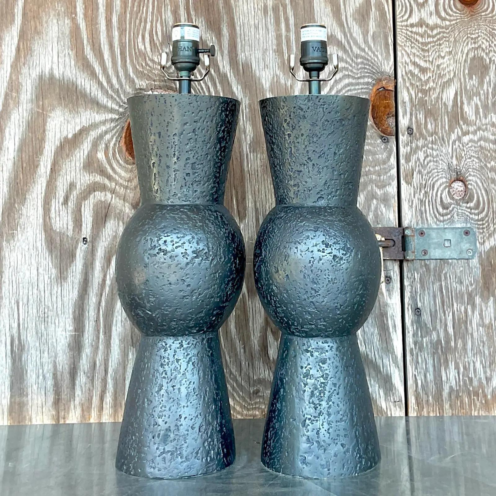 A fantastic pair of vintage Contemporary table lamps. Made by the chic Vaughan group. Patinated bronze over heavy brass in a abstract hourglass shape. Acquired from a Palm Beach estate.