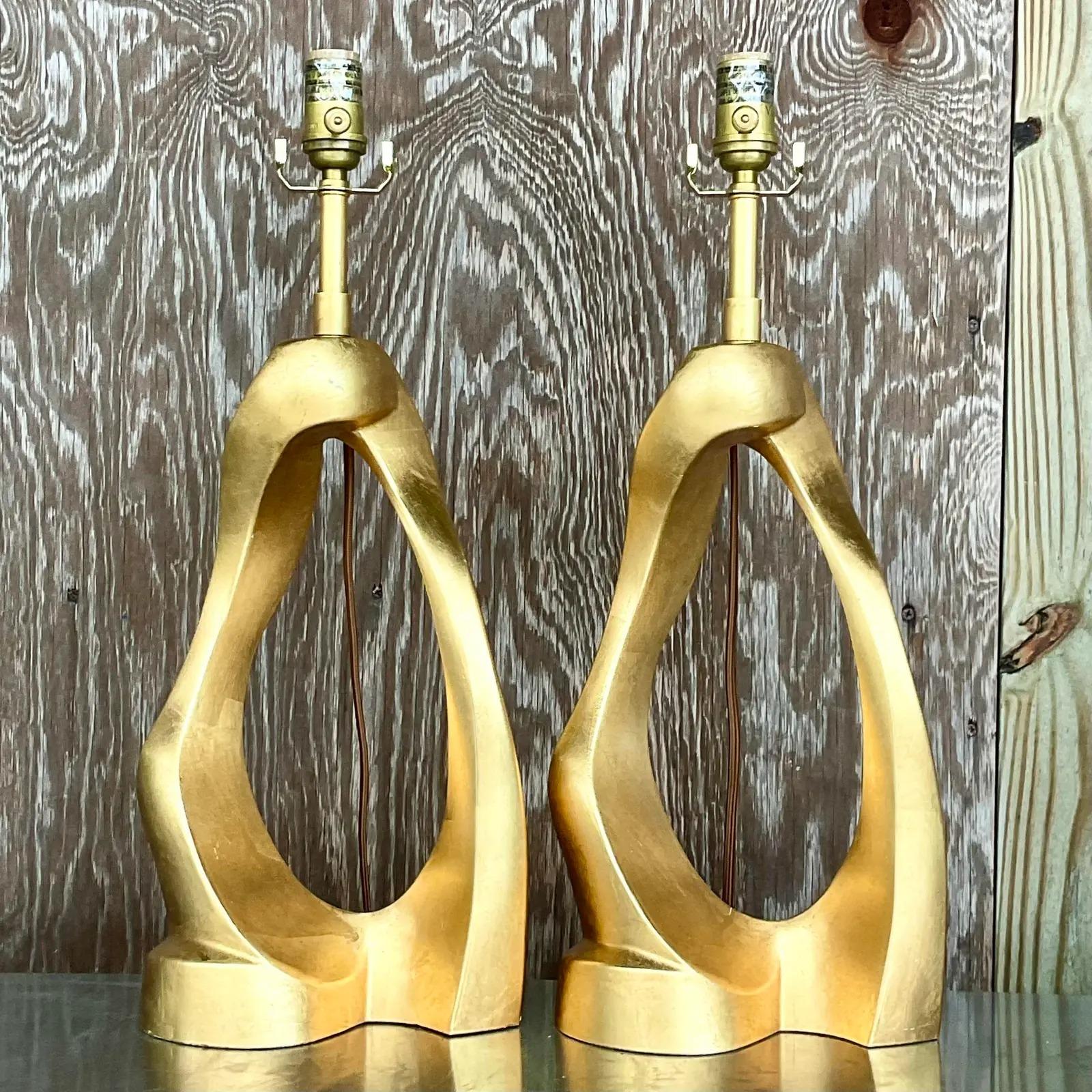 A stunning pair of vintage contemporary table lamps. Made by Aerin for Visual Comfort. The gorgeous abstract sculpted Cannes style. A matte gold finish. Acquired from a Palm Beach estate.

The lamps are in great vintage condition. Minor scuffs and