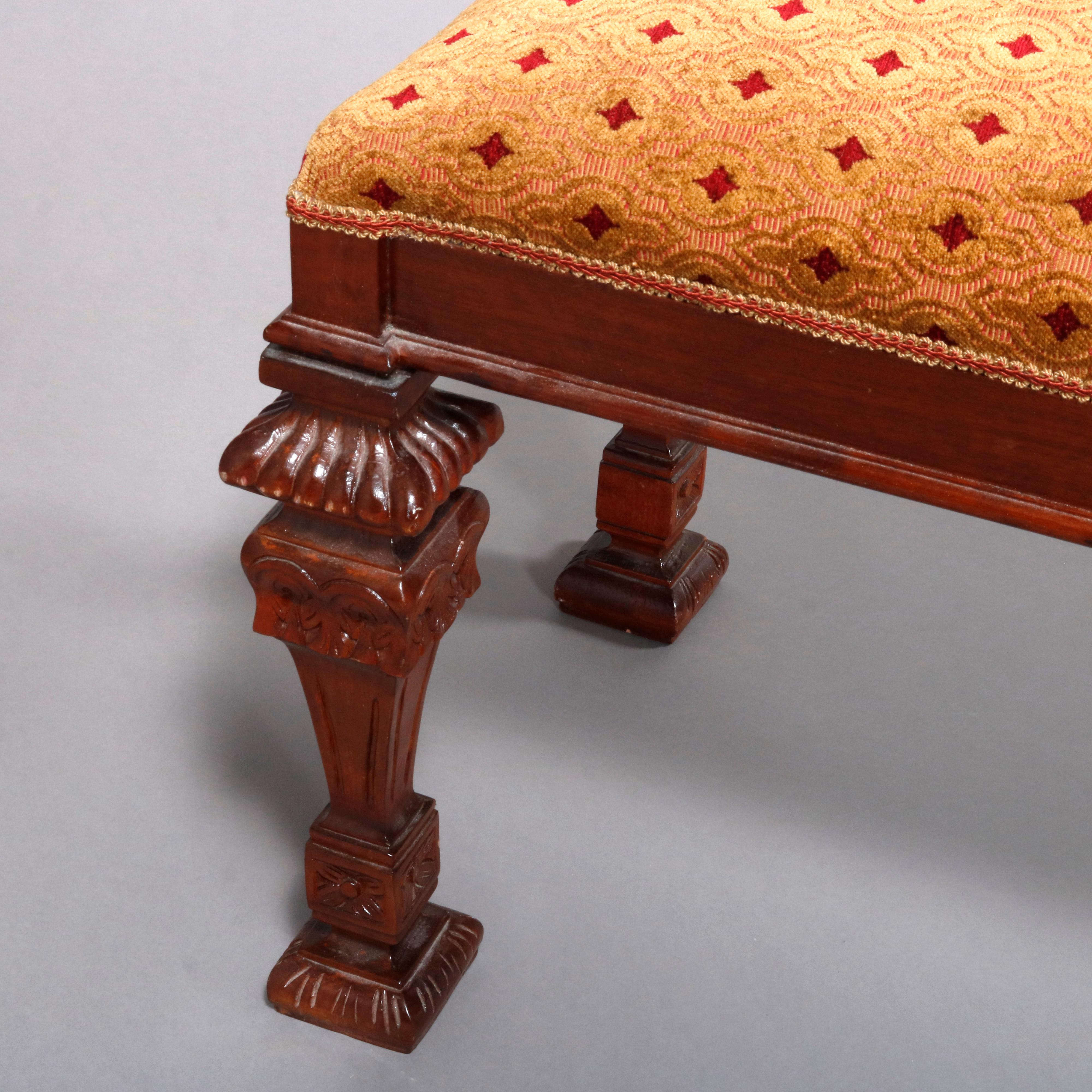 A vintage continental long bench offers upholstered seat surmounting carved mahogany frame with square and tapered legs having gadroon and floral decoration, 20th century

Measures: 21.5