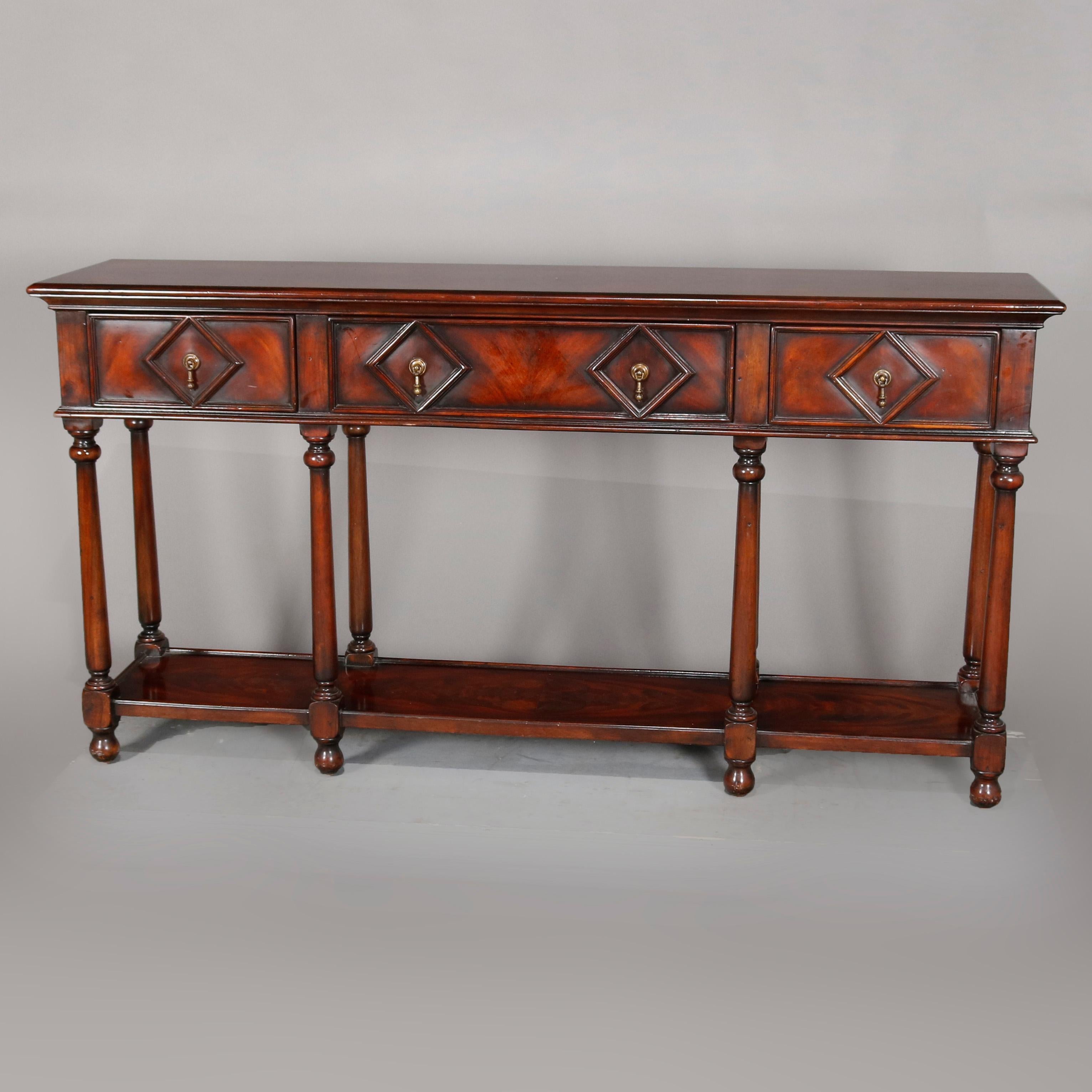 A vintage Continental mahogany silver server offers flame mahogany construction with deeply striated top surmounting case with three drawers, each having geometric diamond reserve, raised on turned legs with lower display shelf, circa