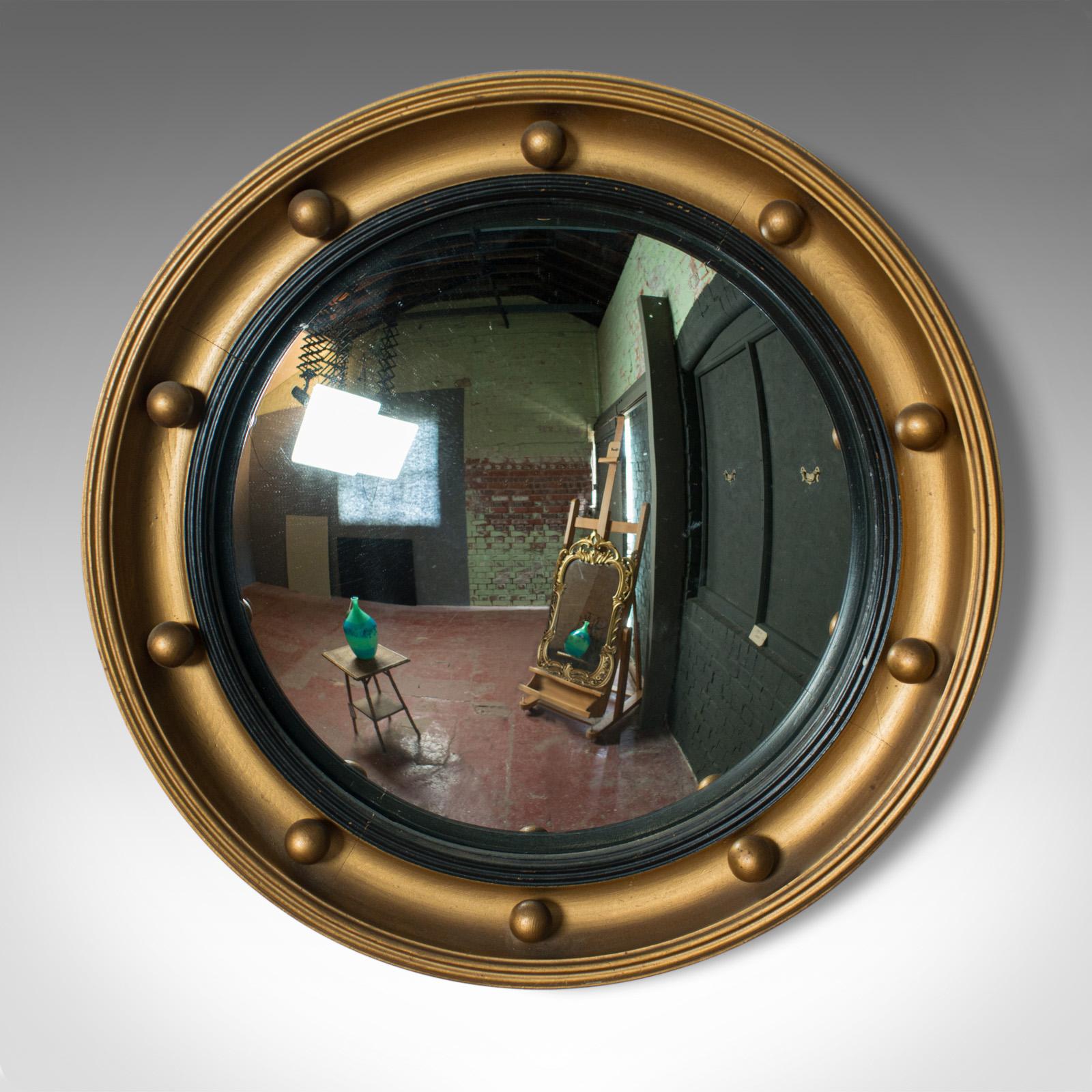 This is a vintage convex wall mirror. An English, midcentury, Victorian revival, circular, porthole mirror dating to circa 1950. 

A classic convex wall mirror
Mirror plate in good order throughout
Giltwood surround crafted in a porthole