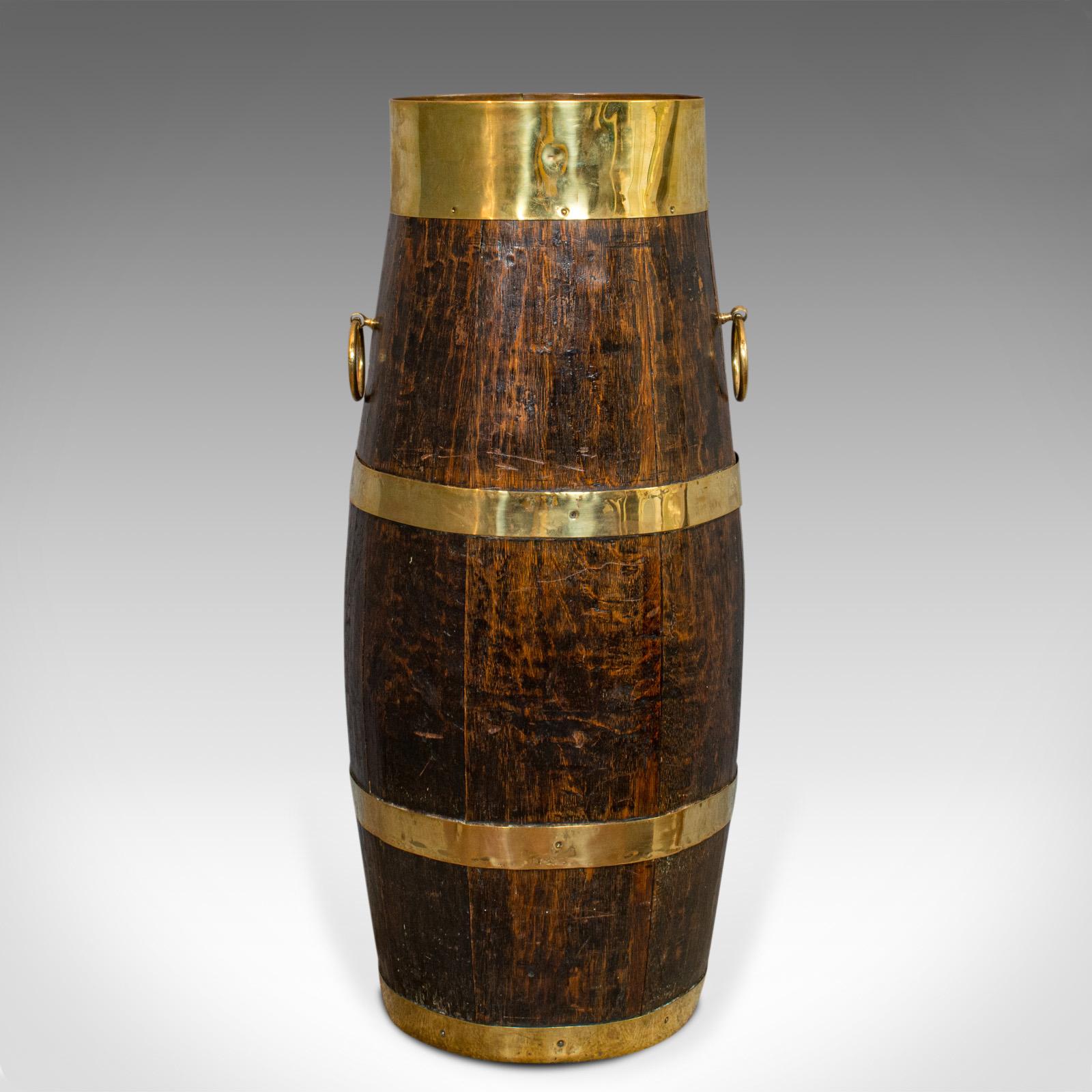 This is a vintage coopered barrel. An English, oak and brass Art Deco stick or umbrella Stand, dating to the early 20th century, circa 1930.

Delightful country inn charm
Displays a desirable aged patina
Rich oak with fine grain interest and