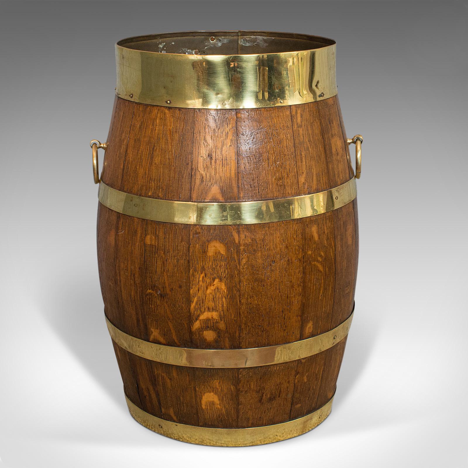 This is a vintage coopered hallway barrel. An English, oak and brass stick or umbrella stand, dating to the early 20th century, circa 1930.

Wonderfully tonal hallway stand
Displays a desirable aged patina
Oak staves with rich colour and wisps