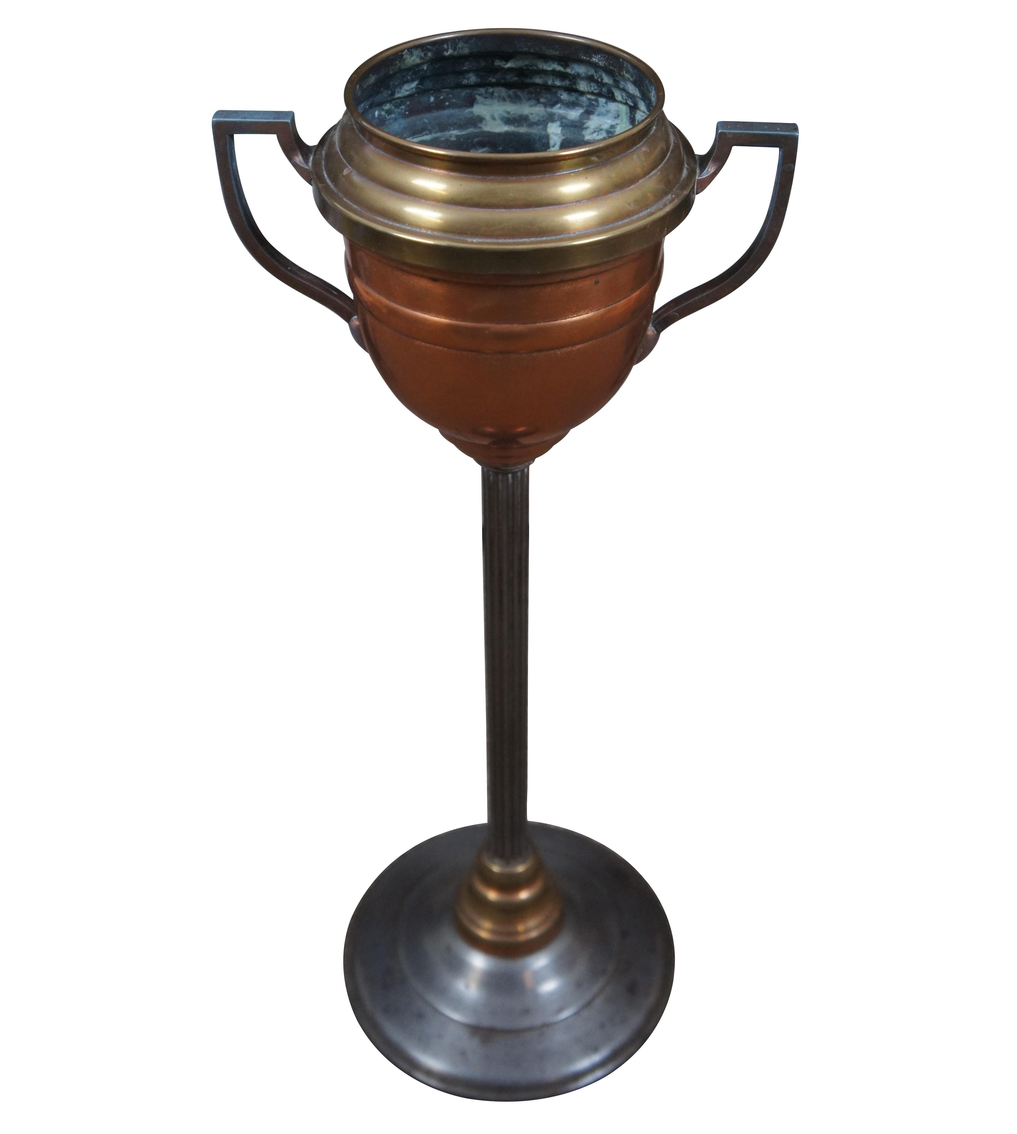 Vintage Mid-20th Century wine chiller / cooler / ice bucket stand with iron base and fluted column supporting a copper and brass neoclassical trophy urn shaped bucket.