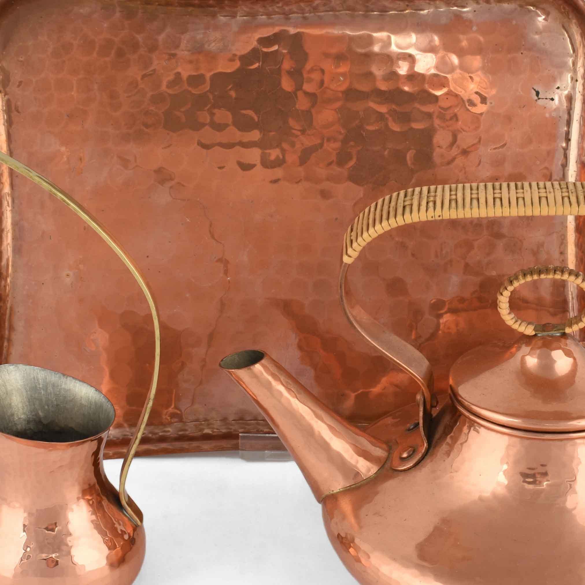 Copper tea pot is an original decorative group of objects realized in the middle of the 20th century.

The group consists of: one tray, one tea pot (dimensions: h 17.5 cm) and one cream server. (Dimensions: 19 cm).

Created by Eugen Zint. Made