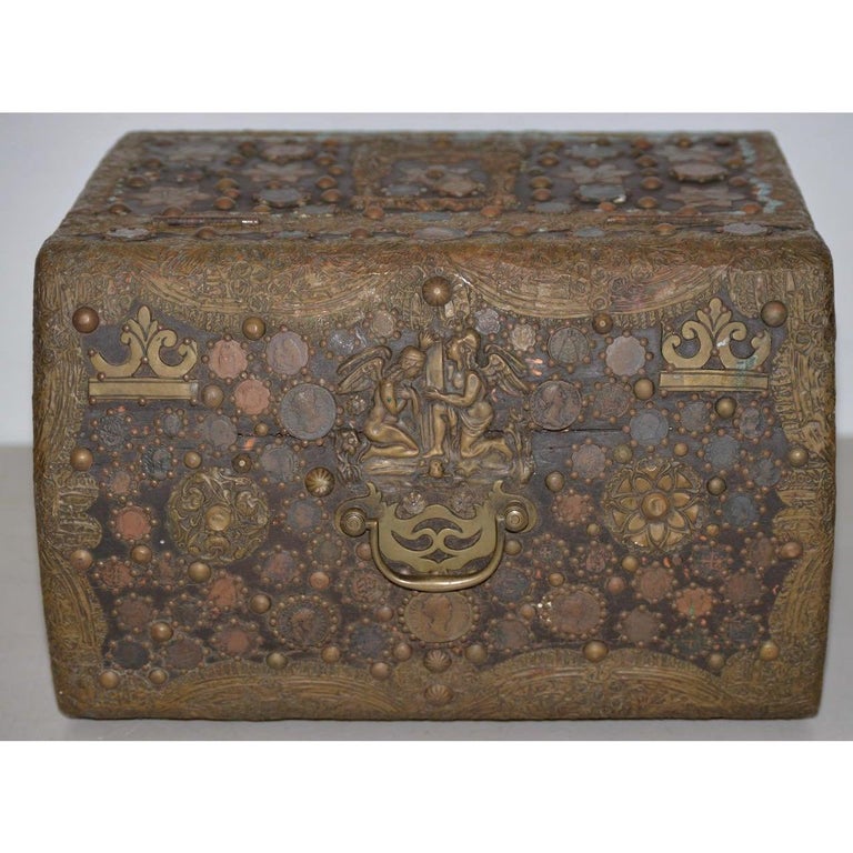 Vintage copper Folk Art box, circa 1940s

Fantastic American Folk Art box made from hand-hammered copper and a collection of antique coins.

Surrounded with a collection of grotesque faces, classical scenes and various patterns.

The interior