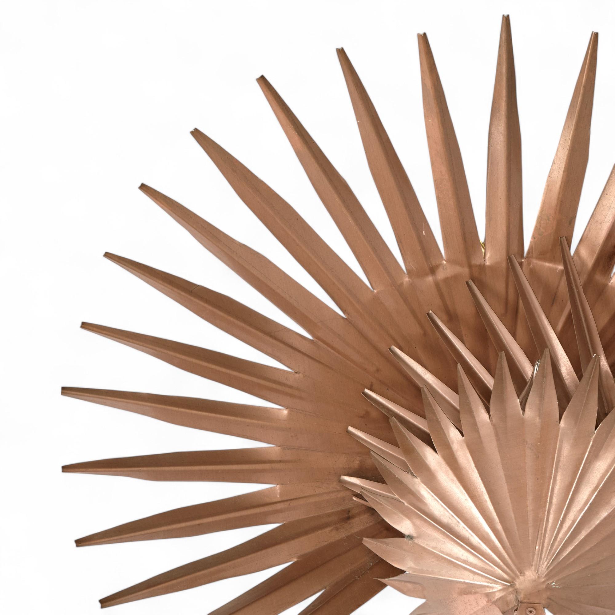 Chic mid century palm leaf sculptural wall sconce handcrafted in copper with three layers of leaves tied with a brass wrap, by Mario Villa, New Orleans. 