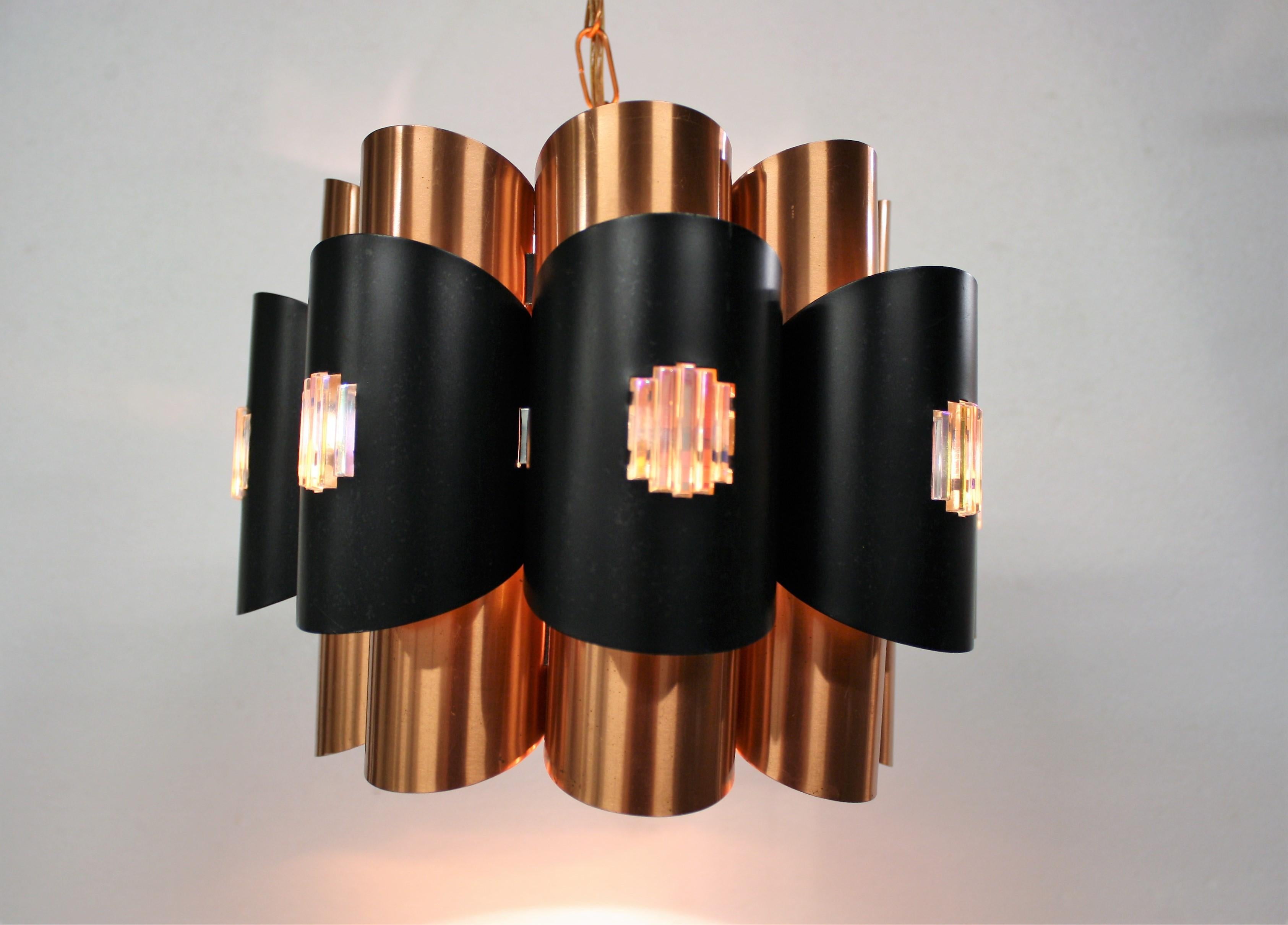 Midcentury scandinavian tubular design pendant light made from copper.

Designed by Werner Schou for Coronell Elektro in the 1960s.

The light consists of two layers of bended metal and copper sheets all brought together to create a beautiful