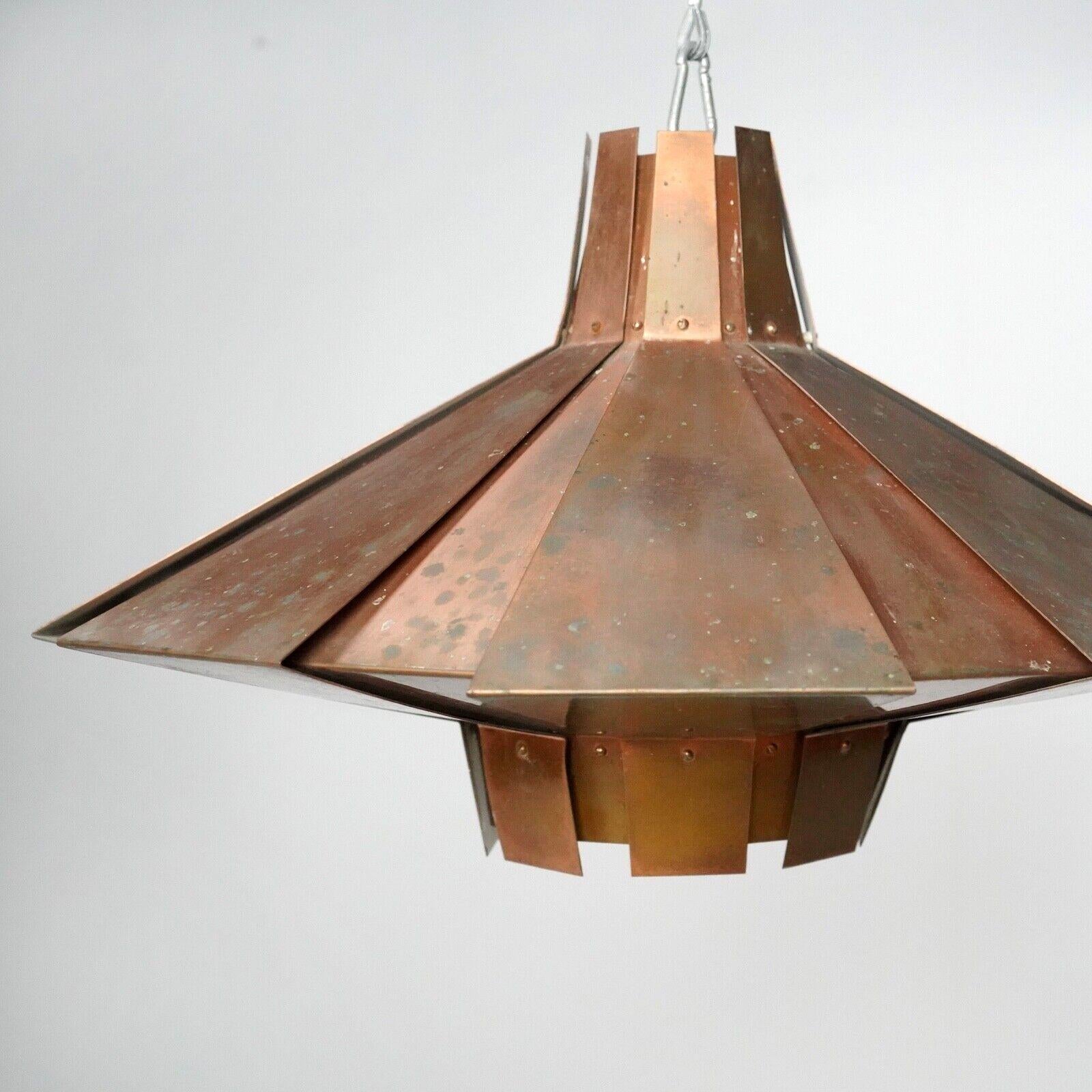 This beautiful patinated Copper Pendant in the style of Werner Schou.
 Its unique copper finish and timeless Scandinavian design will add a touch of sophistication to any home. 
Made from sheet copper, the design allows warm light to spill out