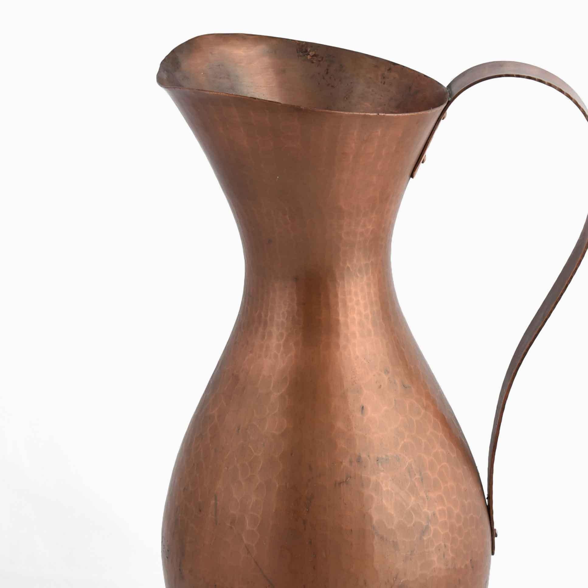 Vintage copper vase or pitcher with handle is an original decorative object realized between the 1950s and the 1960s.

Created by Eugen Zint, made in Germany.

The signature of Zint is impressed on the base of the work. 

Good conditions: